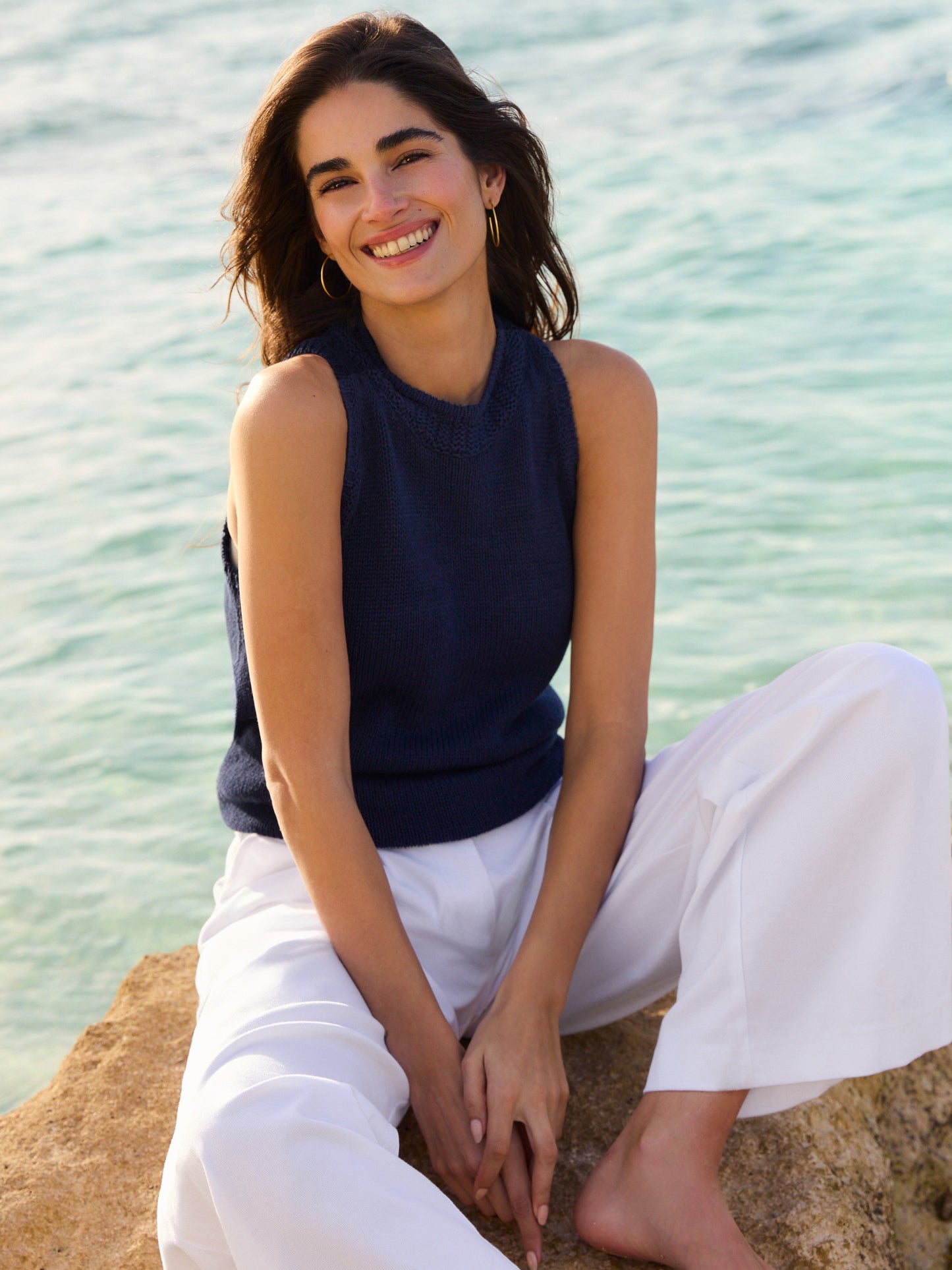J.McLaughlin model wears Felicity Sleeveless Sweater in navy made with cotton/linen.