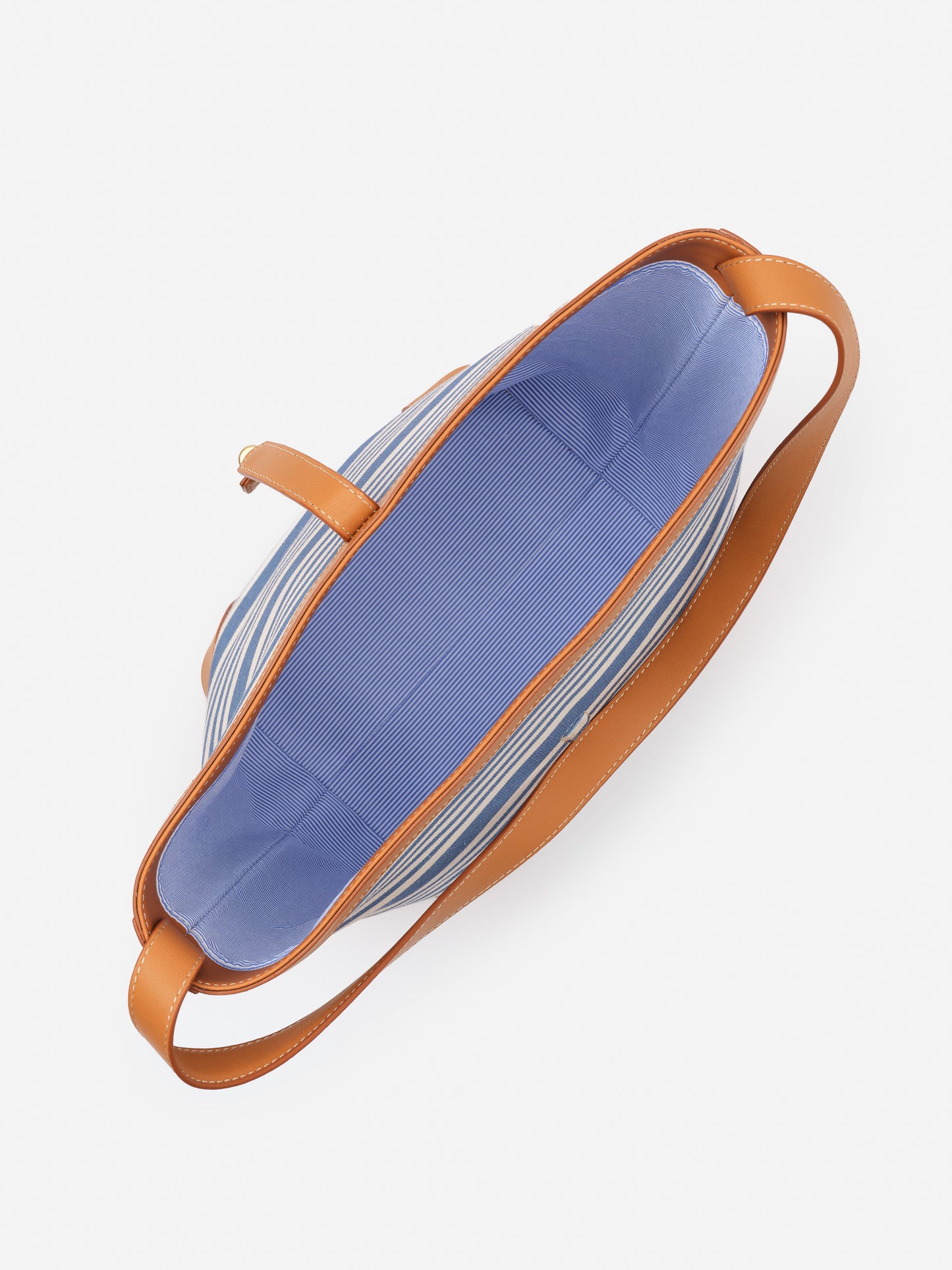 Open top view of Crawford Handbag in Stripe with blue fabric interior and tan leather straps, showcasing J.McLaughlin’s effortlessly stylish, enduring design and craftsmanship.