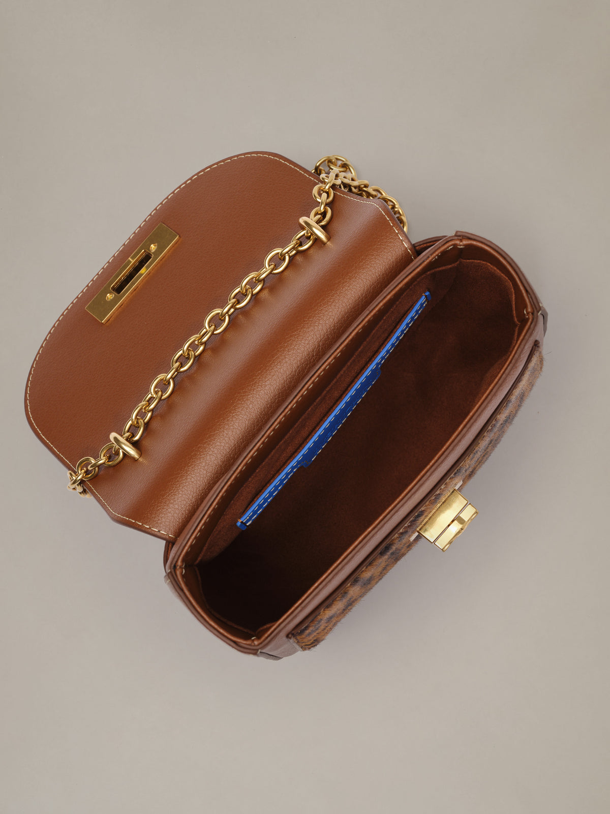 The Waverly Leather Handbag in Leopard by J.McLaughlin open brown leather bag with gold chain strap and blue interior card slot