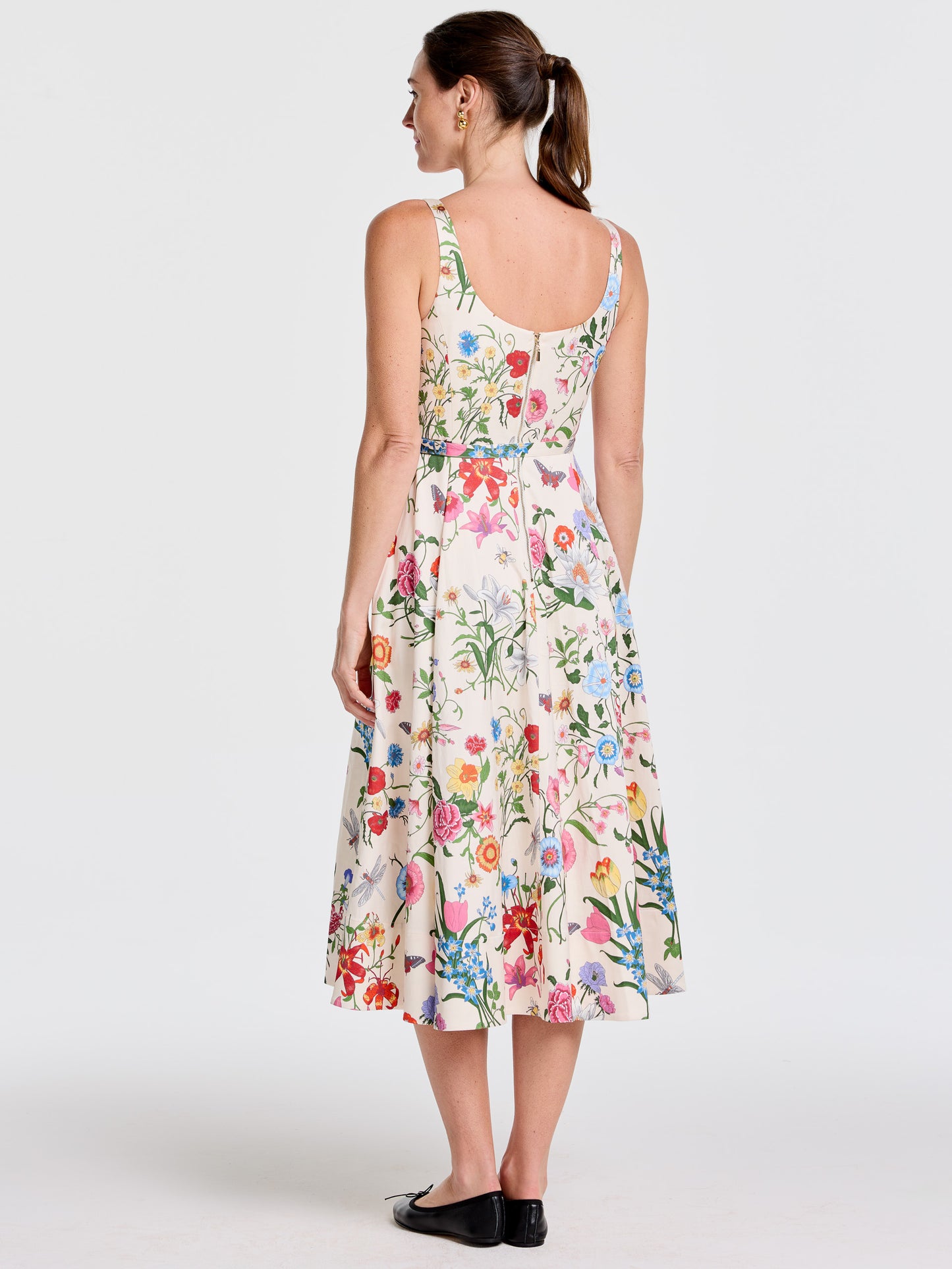 Woman wearing the Charlotte Dress in Dragonfly Garden by J.McLaughlin, featuring a floral print with vibrant colors, showcasing effortlessly stylish, enduring designs and a legacy of timeless fashion.