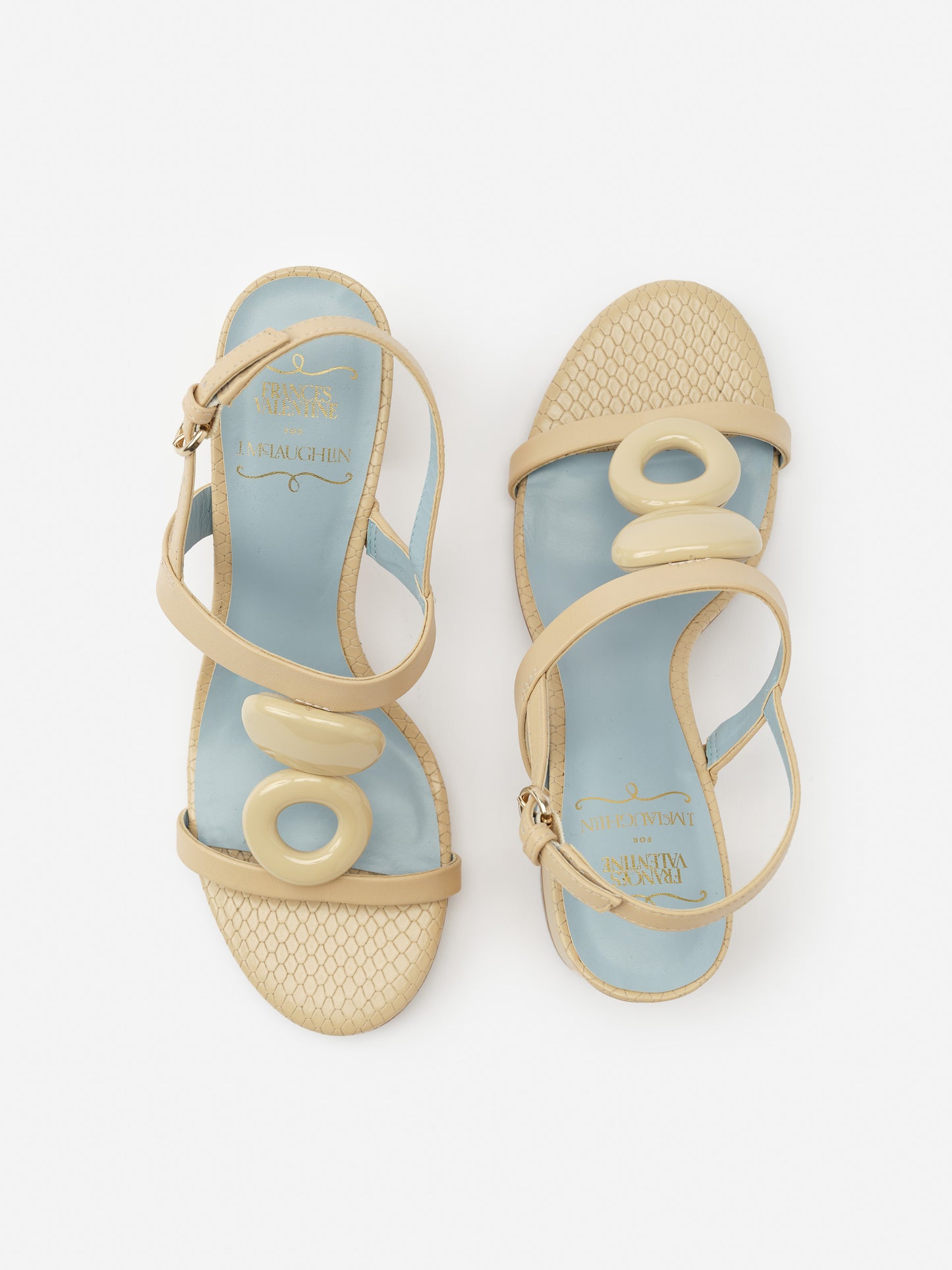 Bianca Heels by J.McLaughlin featuring beige straps with circular accents and textured pattern, effortlessly stylish shoes reflecting enduring designs and a legacy of timeless fashion.