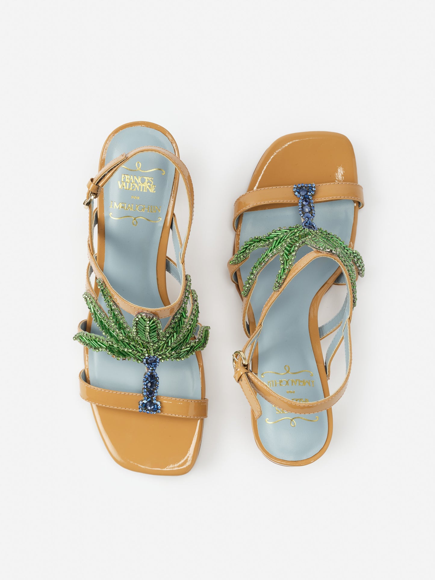 Venus Palm Tree Heels by J.McLaughlin featuring tan leather straps and intricate green and blue beaded palm tree embellishments on a light blue footbed, effortlessly stylish and enduring designs, innovative fabrics, legacy of timeless fashion, a destination for defining style. Life, Well-Lived.