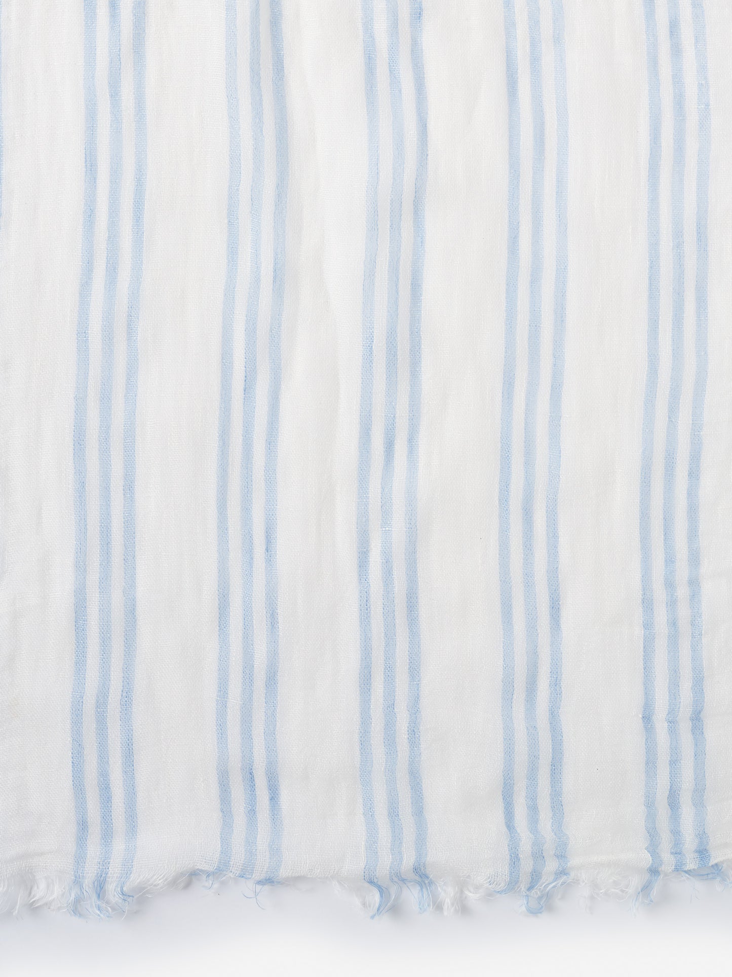 Lightweight Tessa Linen Scarf in Stripe by J.McLaughlin features soft blue and white stripes, crafted with innovative fabrics for effortlessly stylish, enduring designs. A destination for defining style. Life, Well-Lived.