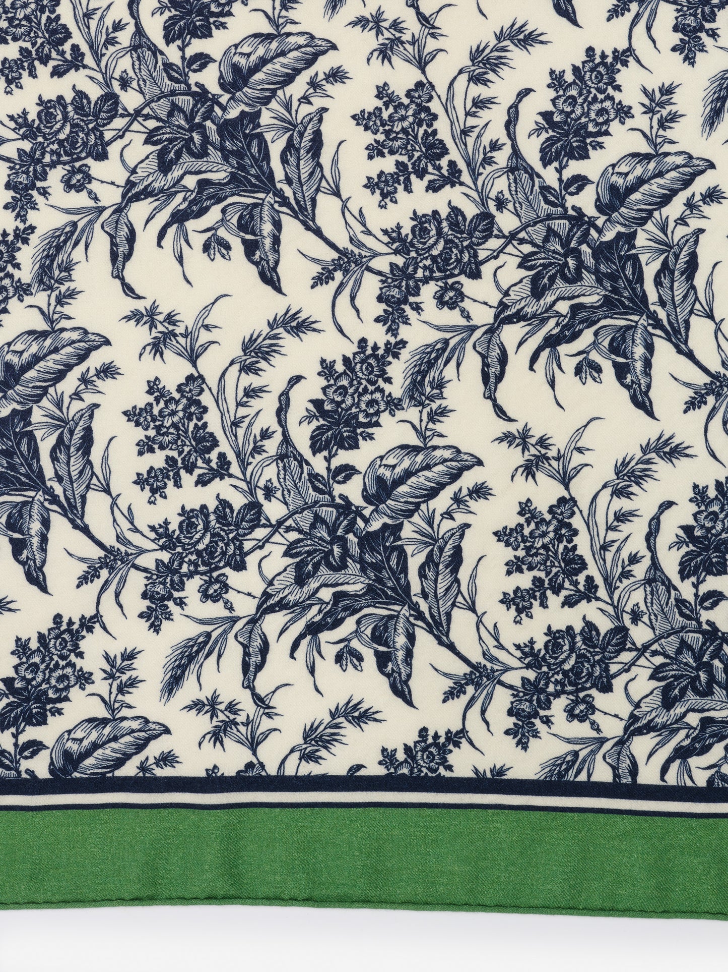 Intricately detailed blue floral pattern on cream fabric with green border of the Sarita Scarf in Giardino Toile Corner by J.McLaughlin, showcasing effortlessly stylish scarves with enduring designs.