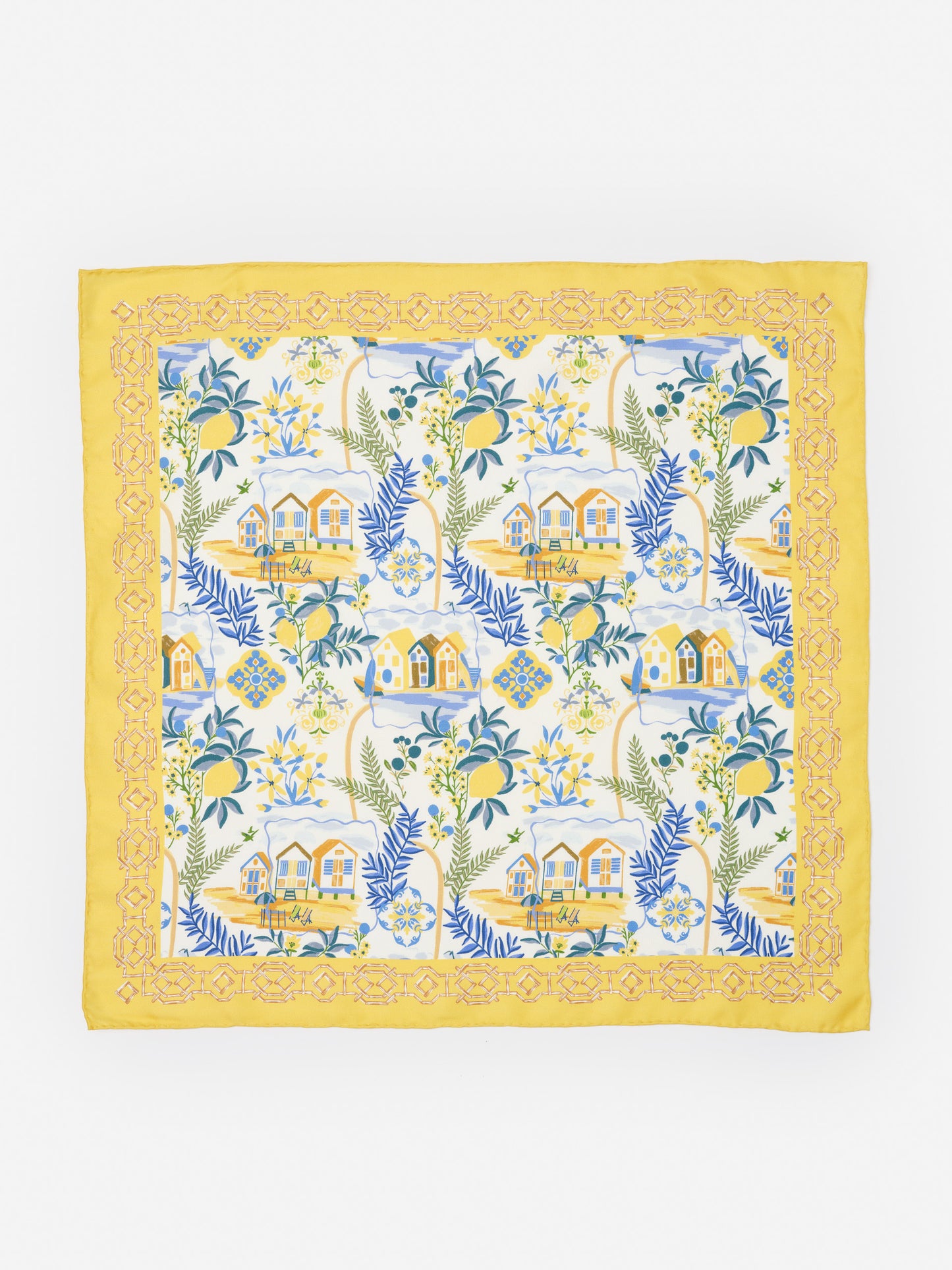 Nikka Silk Scarf in Amalfi Coast Bamboo by J.McLaughlin features a yellow border with intricate patterns framing a coastal scene of houses, lemons, and leafy branches, showcasing effortlessly stylish design and innovative fabrics in an enduring accessory. A destination for defining style. Life, Well-Lived.
