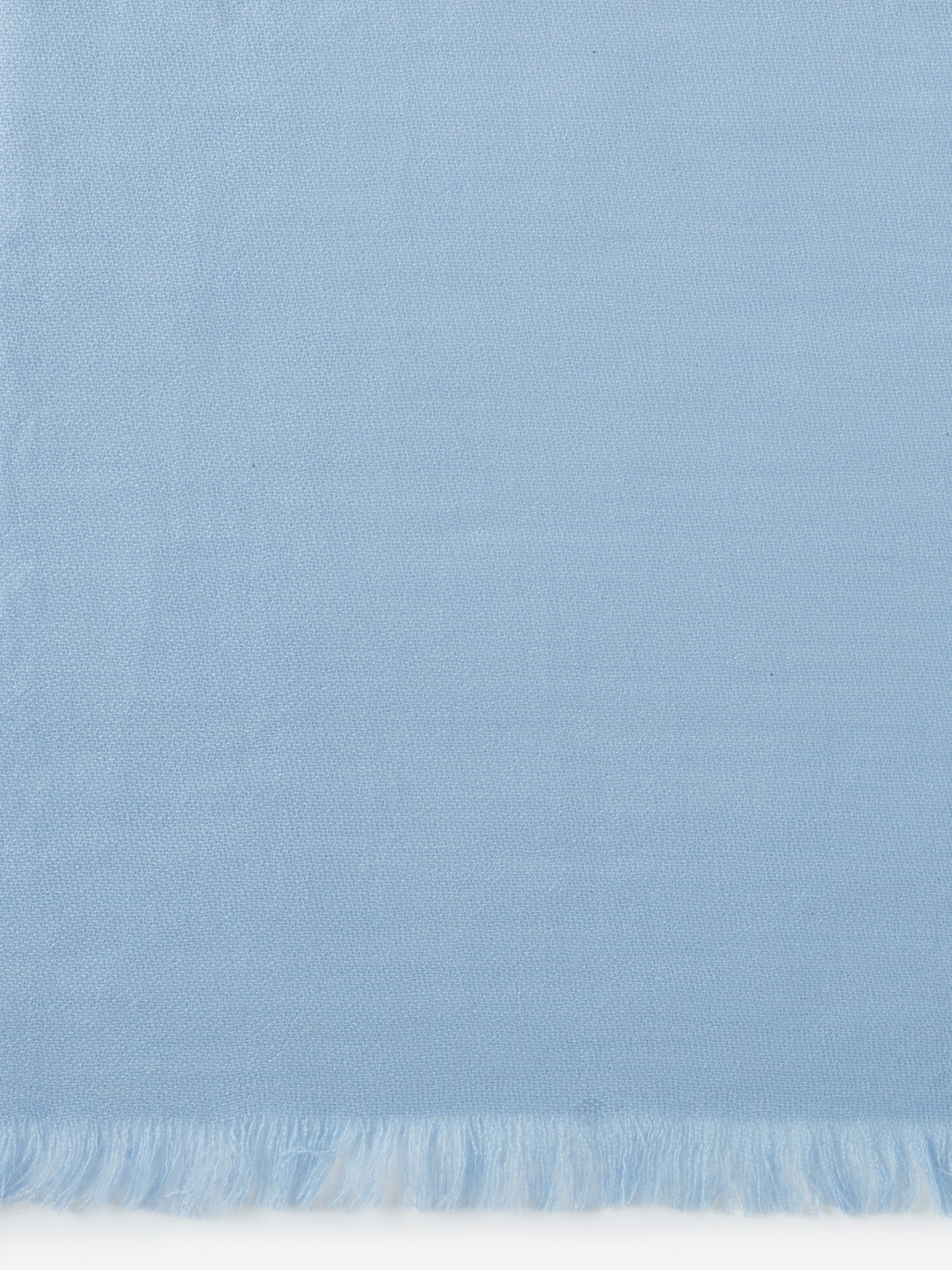 Light blue Carey Cashmere Scarf by J.McLaughlin featuring finely woven fabric and delicate fringe edges, embodying effortlessly stylish, enduring designs with a legacy of timeless fashion.