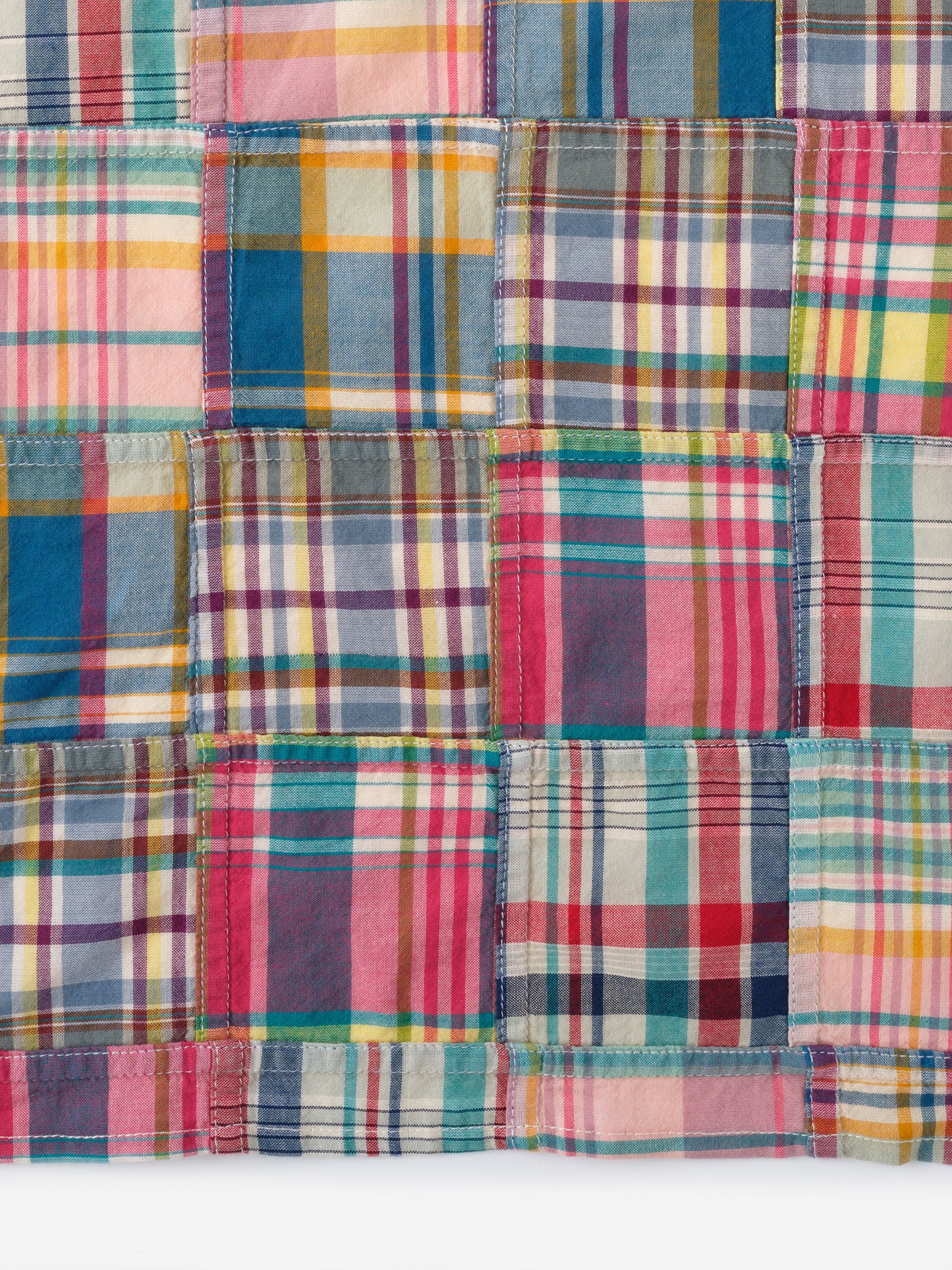 Close-up of a colorful plaid fabric pattern showcasing the Men's Cotton Scarf in Plaid by J.McLaughlin, reflecting effortlessly stylish, enduring designs with a legacy of timeless fashion. A destination for defining style. Life, Well-Lived.