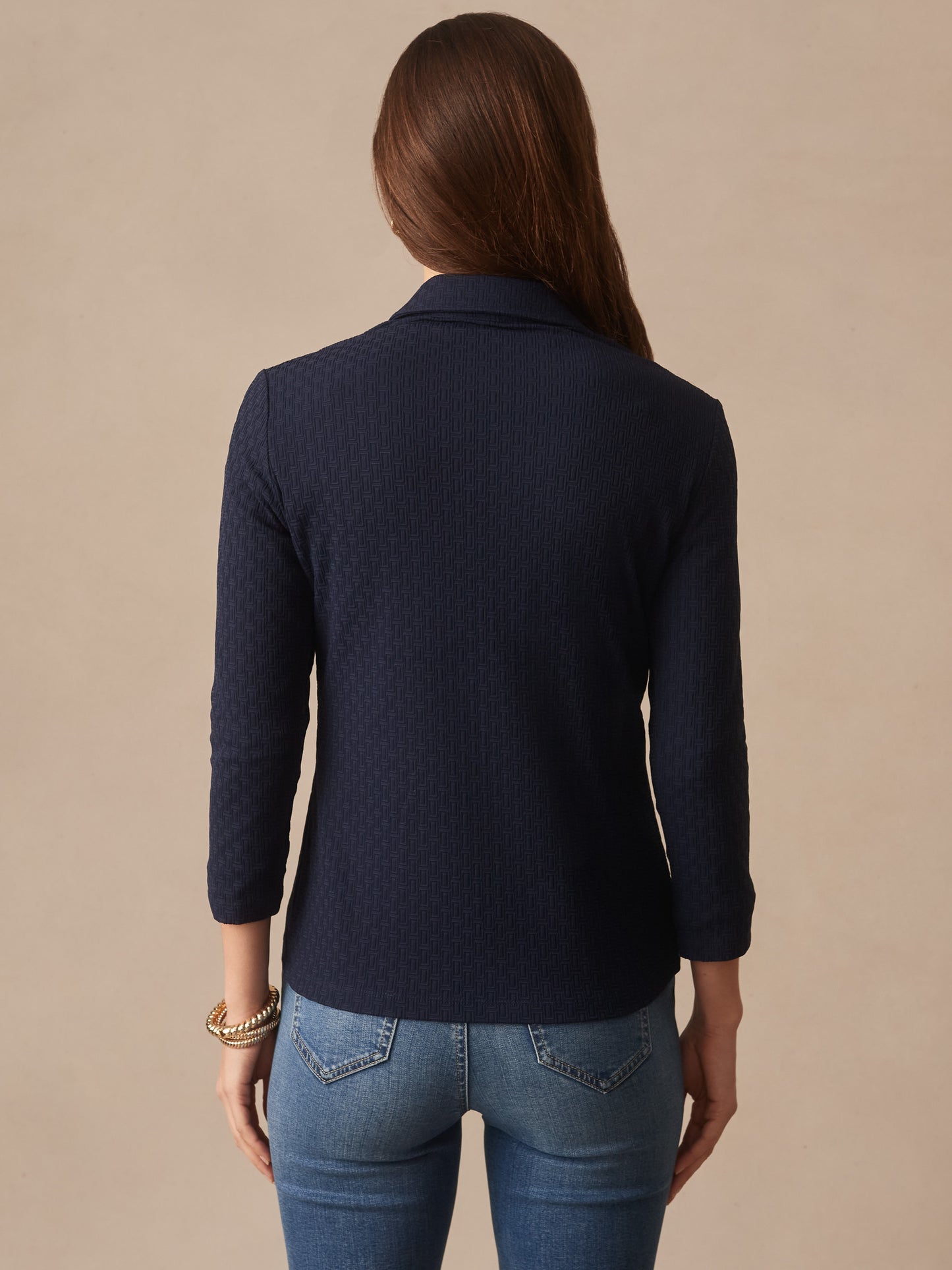 Woman wearing a navy Aida 3/4 Sleeve Top in Dashing Jacquard by J.McLaughlin, featuring innovative fabrics and enduring designs for effortlessly stylish, timeless fashion.