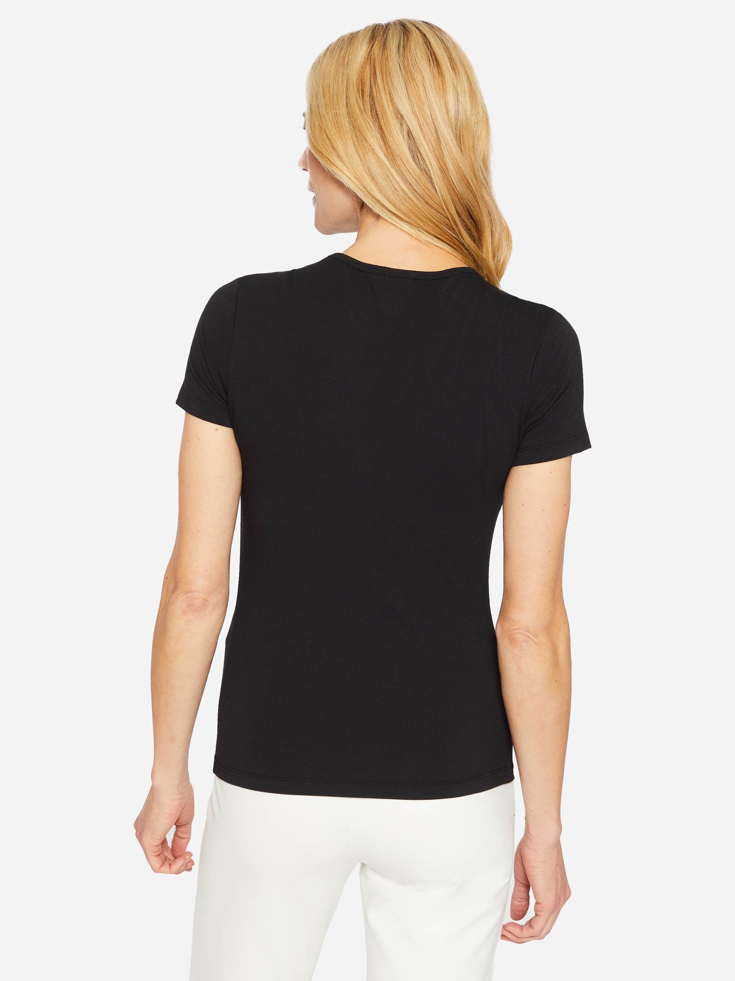 Model wearing J.McLaughlin Allie cap sleeve tee in black made with cotton/modal.