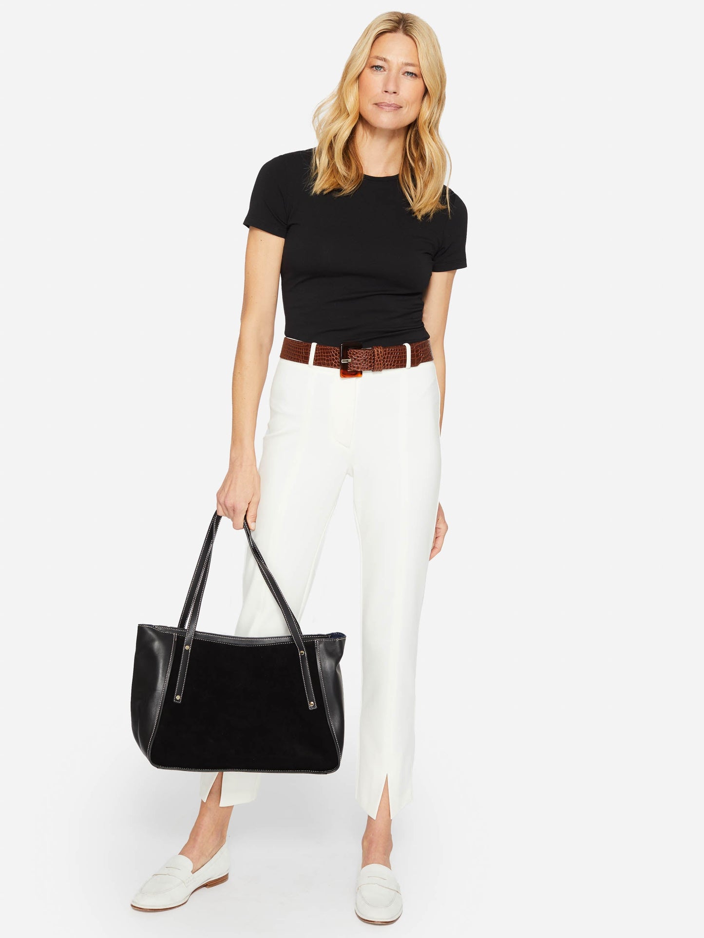 Model wearing J.McLaughlin Allie cap sleeve tee in black made with cotton/modal.