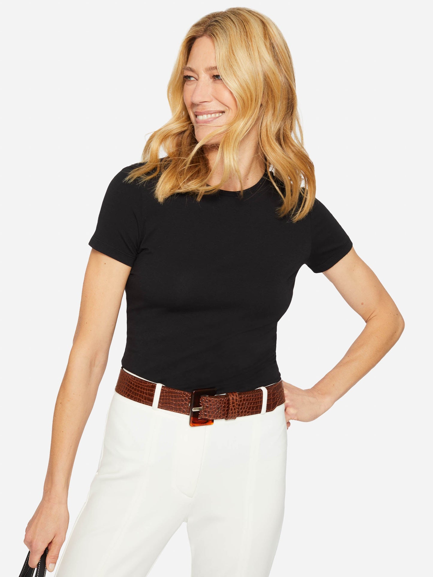 Model wearing J.McLaughlin Allie cap sleeve tee in black made with cotton/modal.