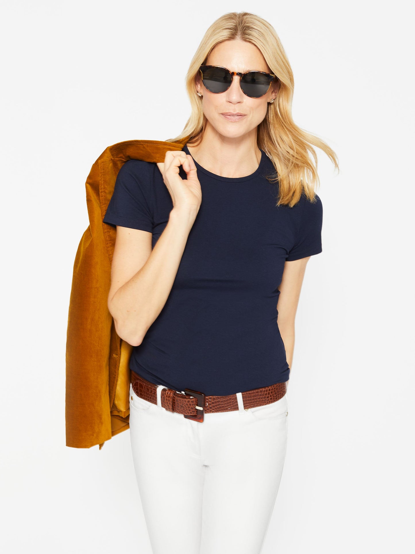 Model wearing J.McLaughlin Allie cap sleeve tee in navy made with cotton/modal.