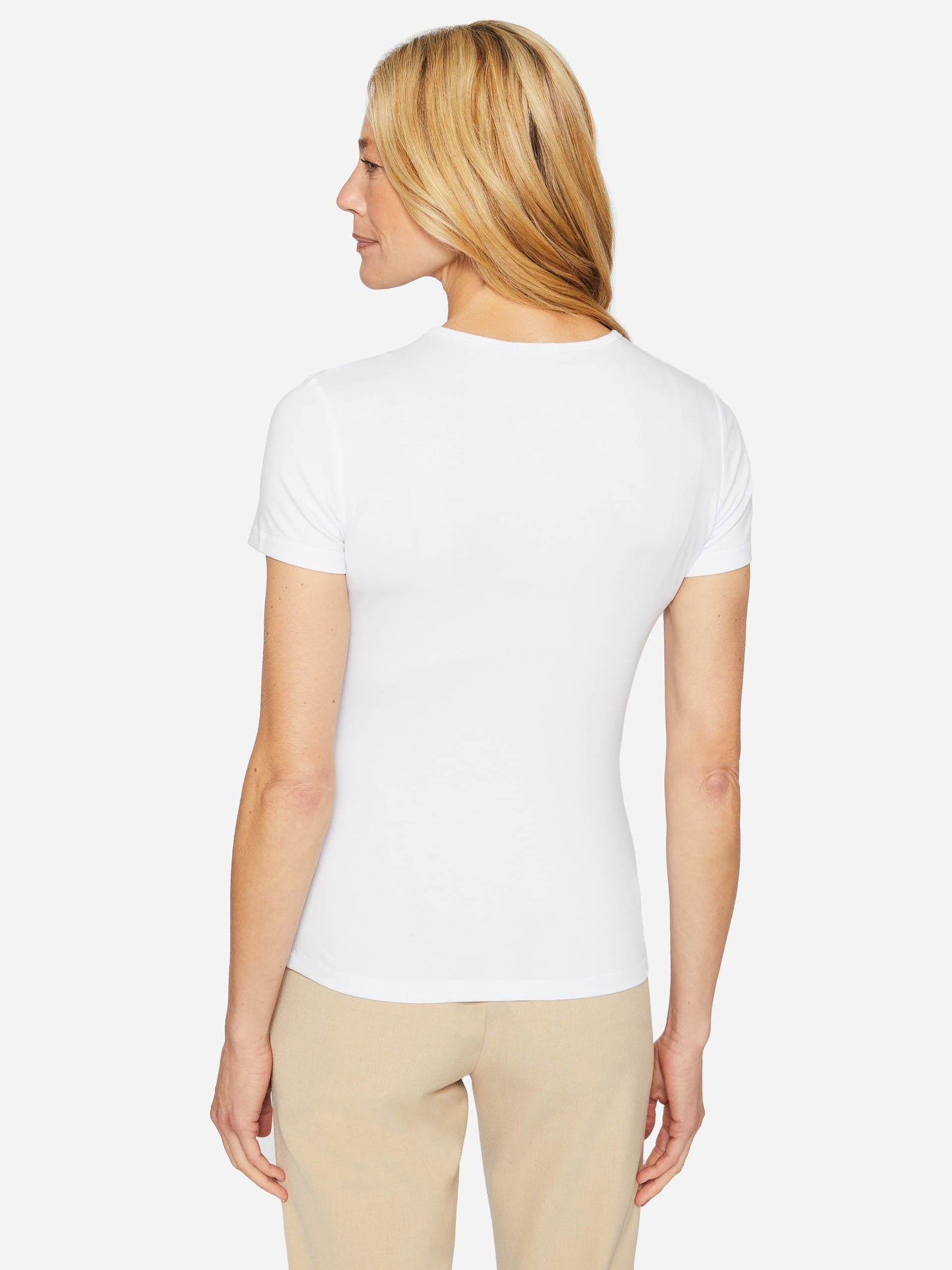 Model wearing J.McLaughlin Allie cap sleeve tee in white made with cotton/modal.