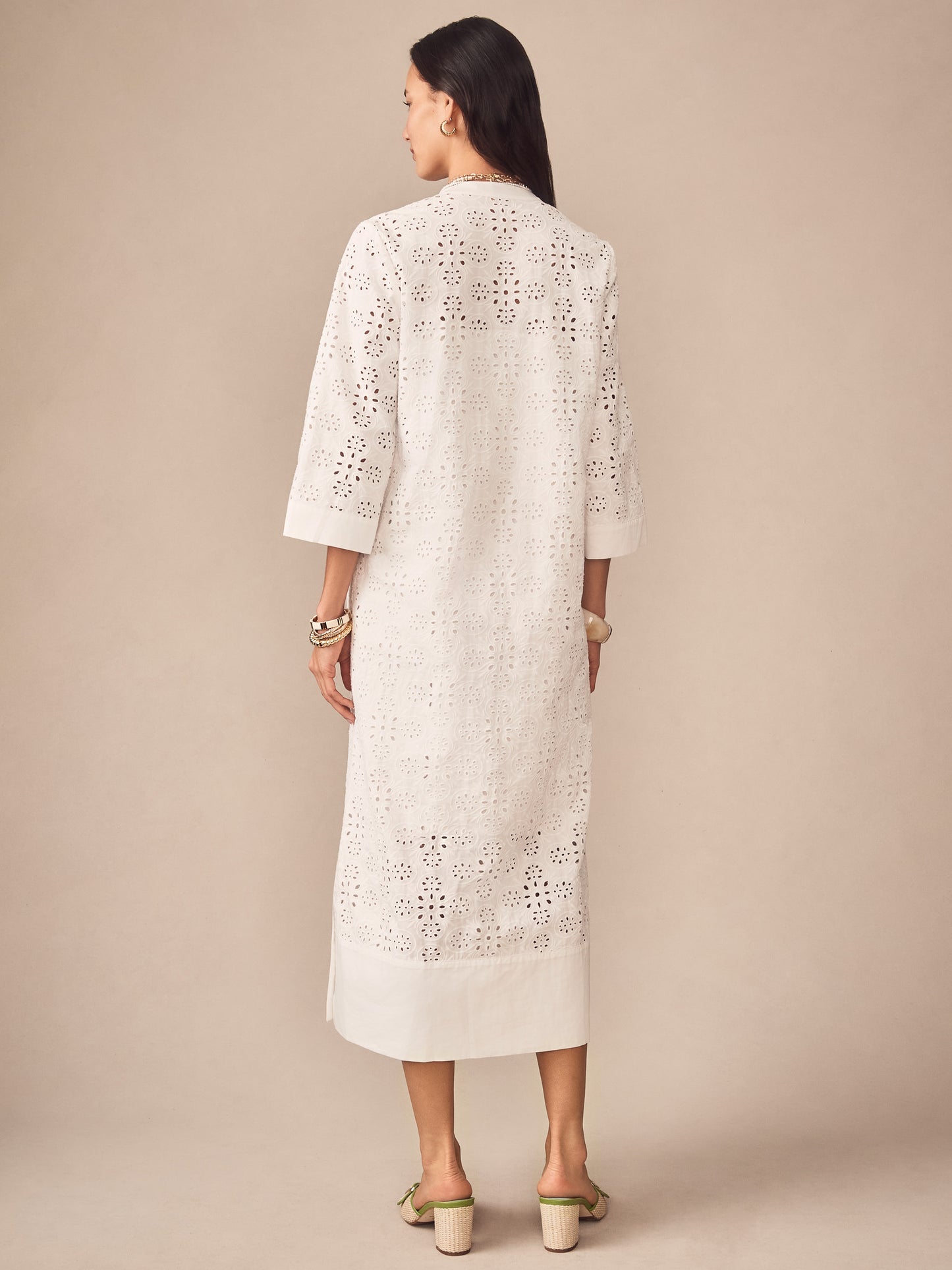 Woman wearing an off-white Cindy Eyelet Dress by J.McLaughlin, featuring intricate eyelet detailing and a relaxed fit, embodying effortlessly stylish and enduring designs.