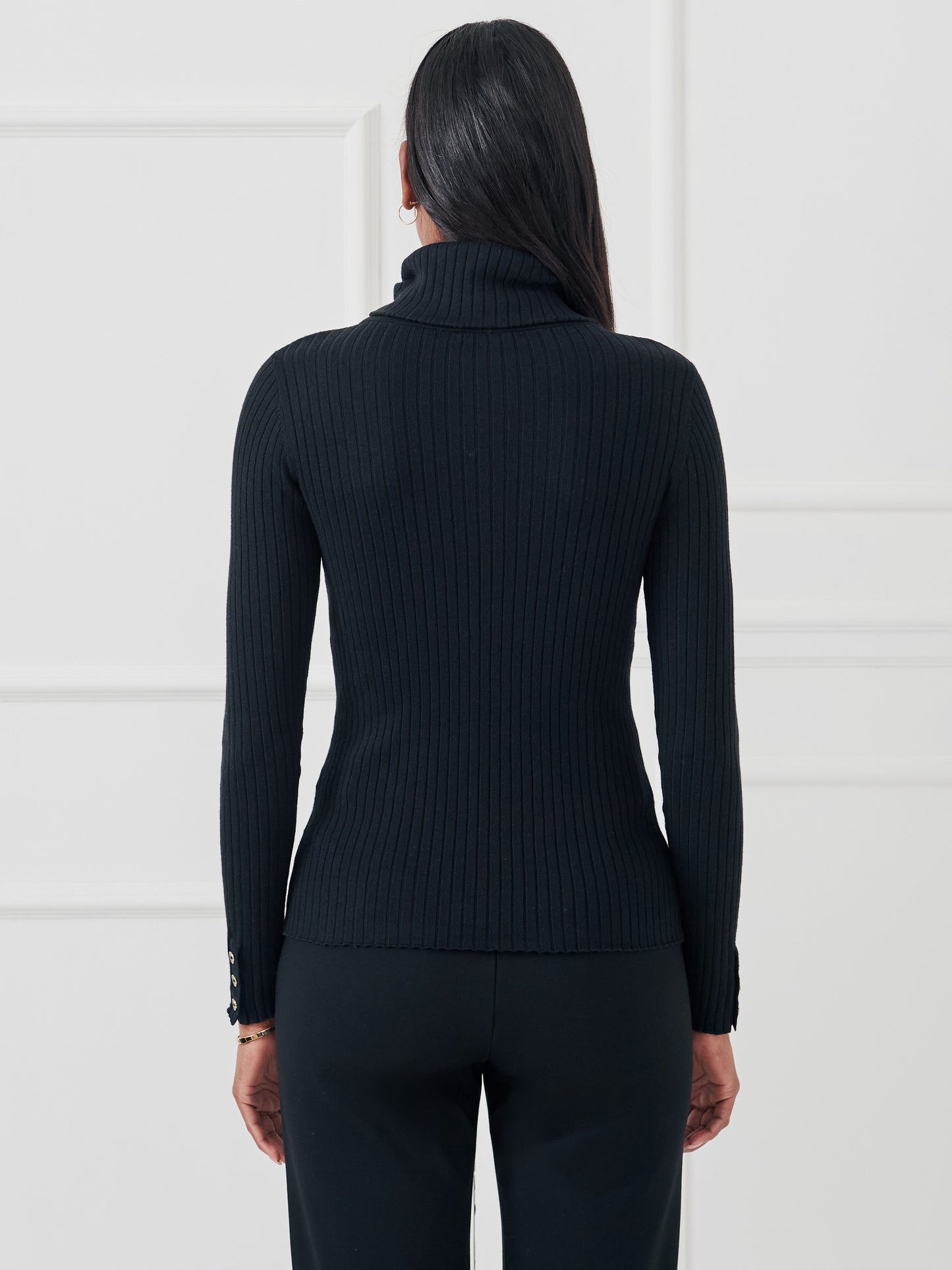 Model wearing J.McLaughlin Arlette turtleneck in black made with cotton/modal.