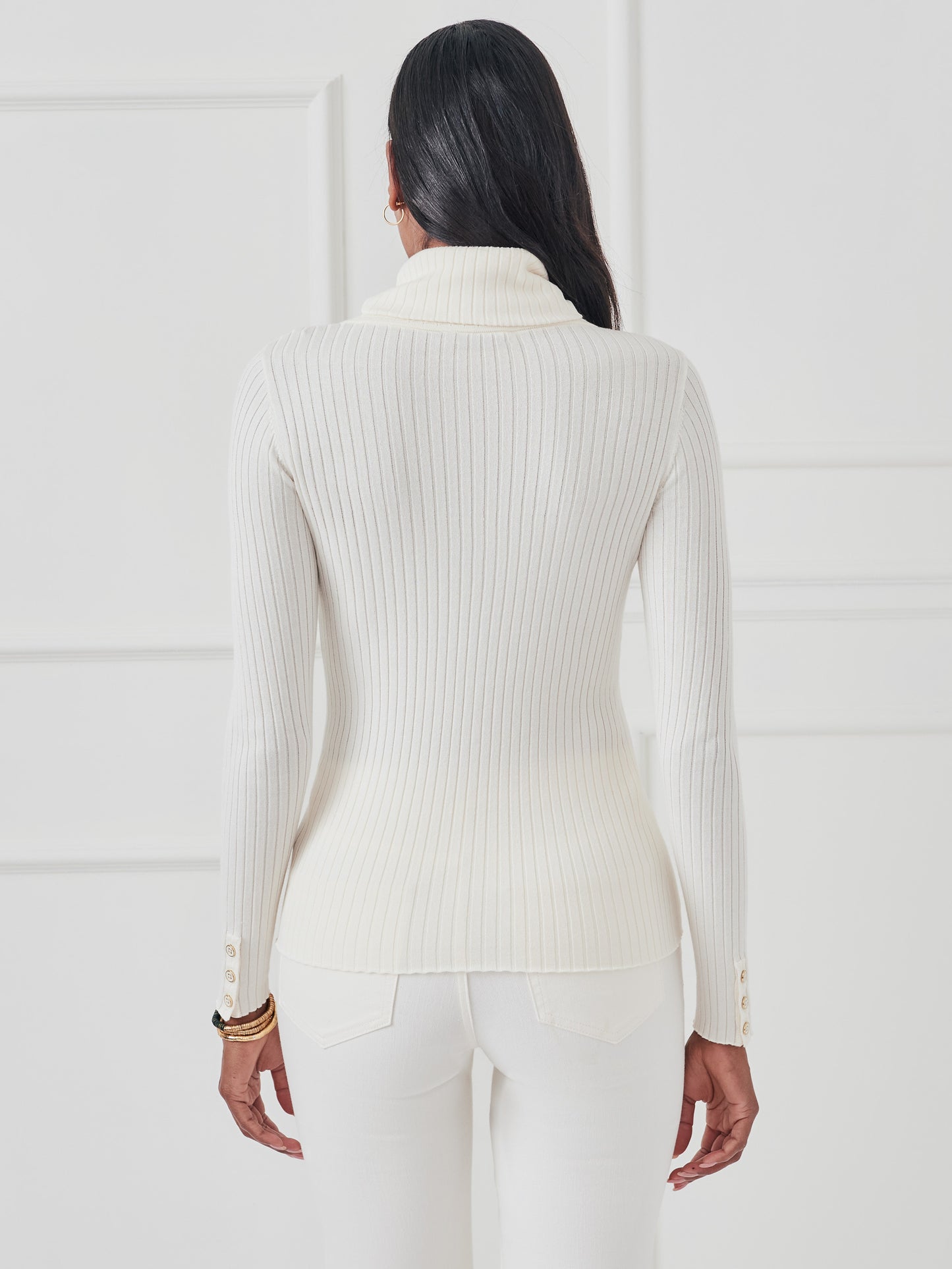 Model wearing J.McLaughlin Arlette turtleneck in egret white made with cotton/modal.