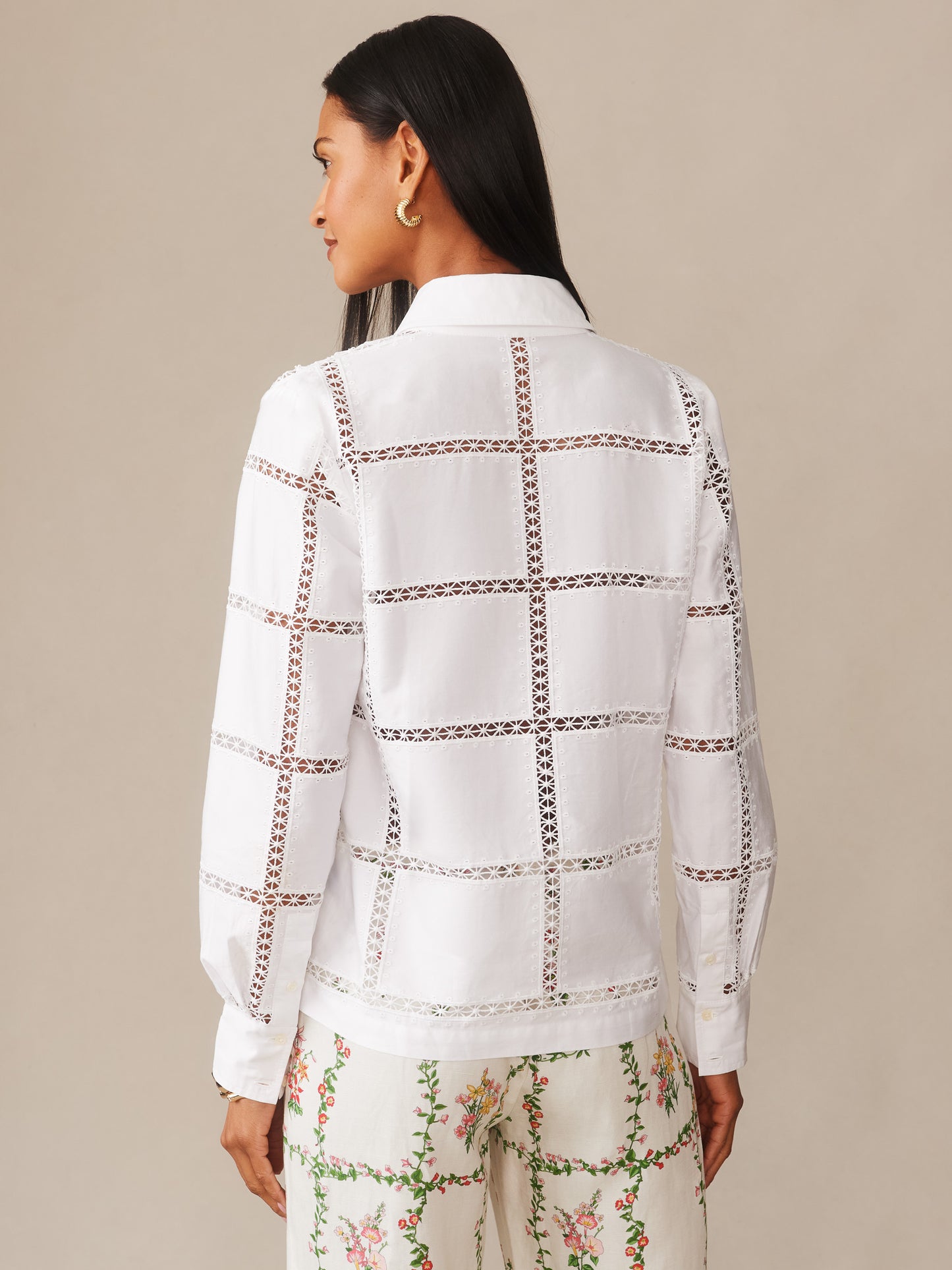 Woman wearing a Kyla Embroidered Shirt by J.McLaughlin, showcasing intricate embroidered grid patterns on a white shirt, reflecting effortlessly stylish, enduring designs and a legacy of timeless fashion.