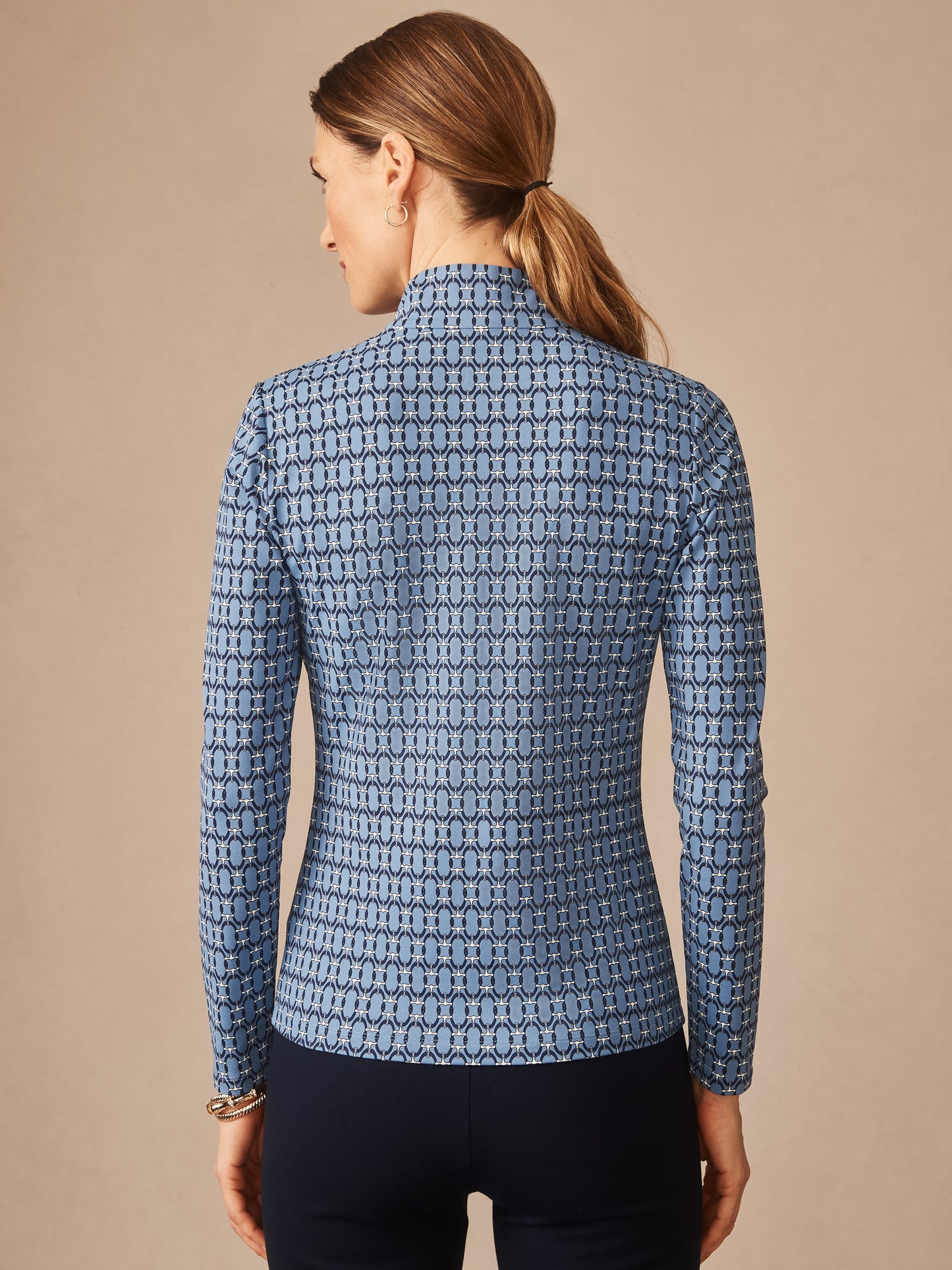 Woman seen from behind wearing a long-sleeve Bedford Top in Signet Lock by J.McLaughlin, featuring a classic patterned design in blue tones, showcasing effortlessly stylish, enduring designs and innovative fabrics in a legacy of timeless fashion. A destination for defining style. Life, Well-Lived.