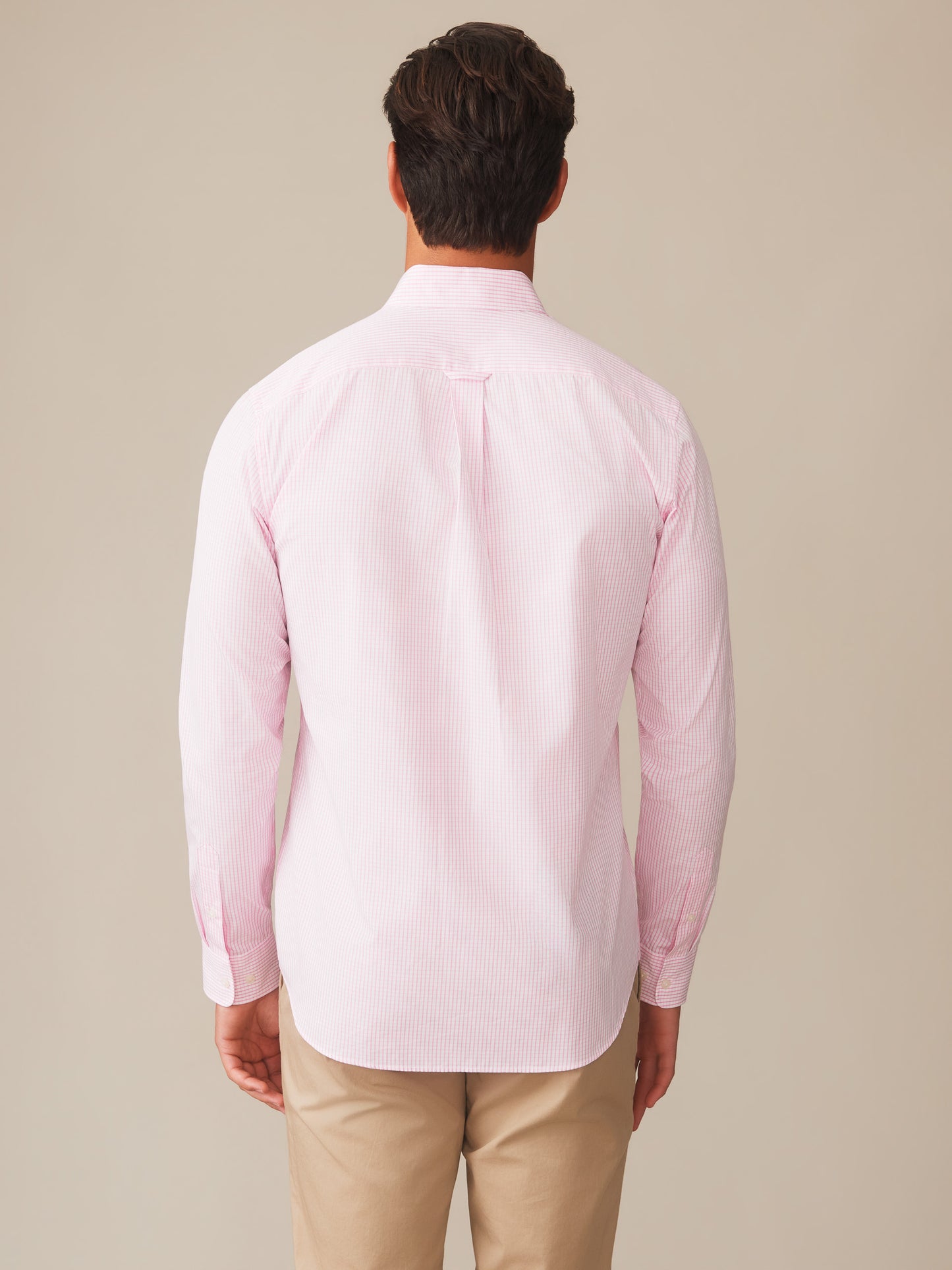 Man wearing a pink Belvedere Cotton Shirt in Graphic Check by J.McLaughlin shown from the back, showcasing effortlessly stylish, enduring designs with innovative fabrics for a legacy of timeless fashion. A destination for defining style. Life, Well-Lived.