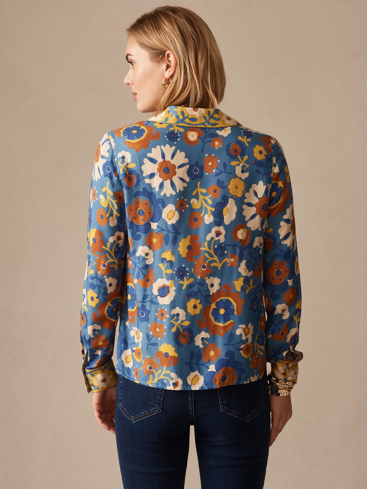 Woman seen from the back wearing a Bimini Shirt in Floral Daydream Edge by J.McLaughlin, featuring a colorful floral pattern on an effortlessly stylish shirt, embodying enduring designs and a legacy of timeless fashion. A destination for defining style. Life, Well-Lived.