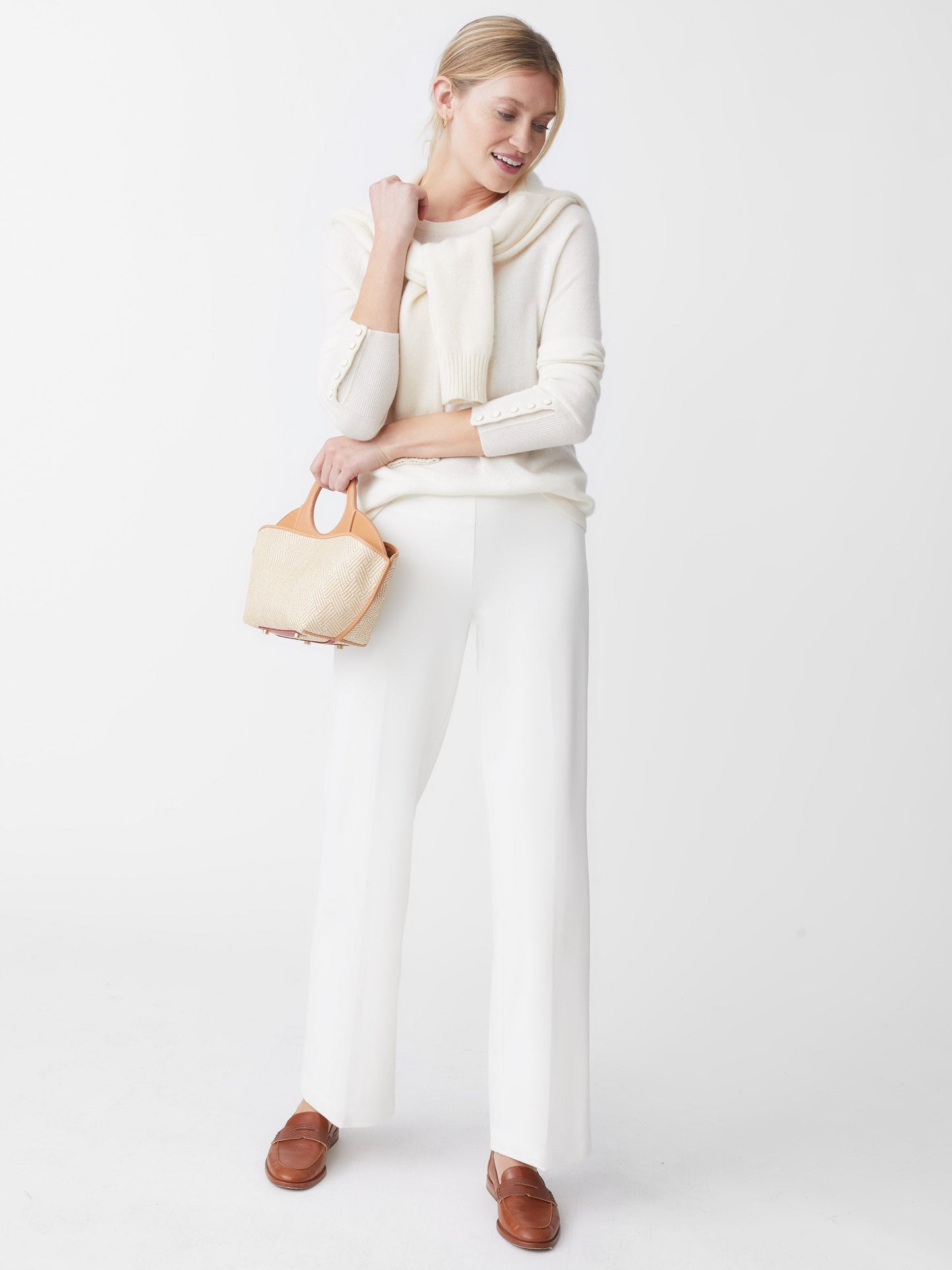 Model wearing J.McLaughlin Carter pants in ivory made with Bainbridge fabric.