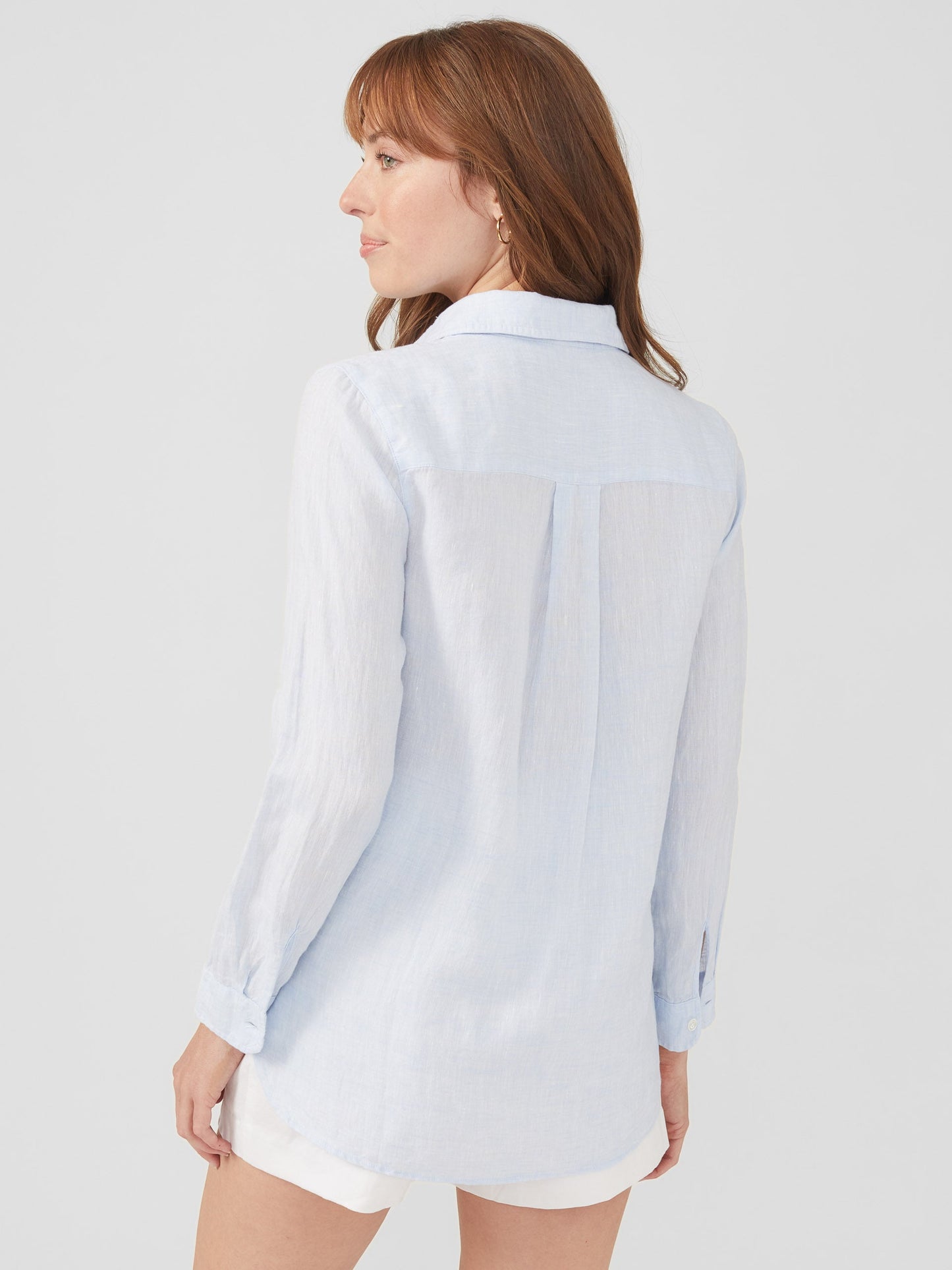 Model wearing J.McLaughlin Britt shirt in sky blue made with linen.