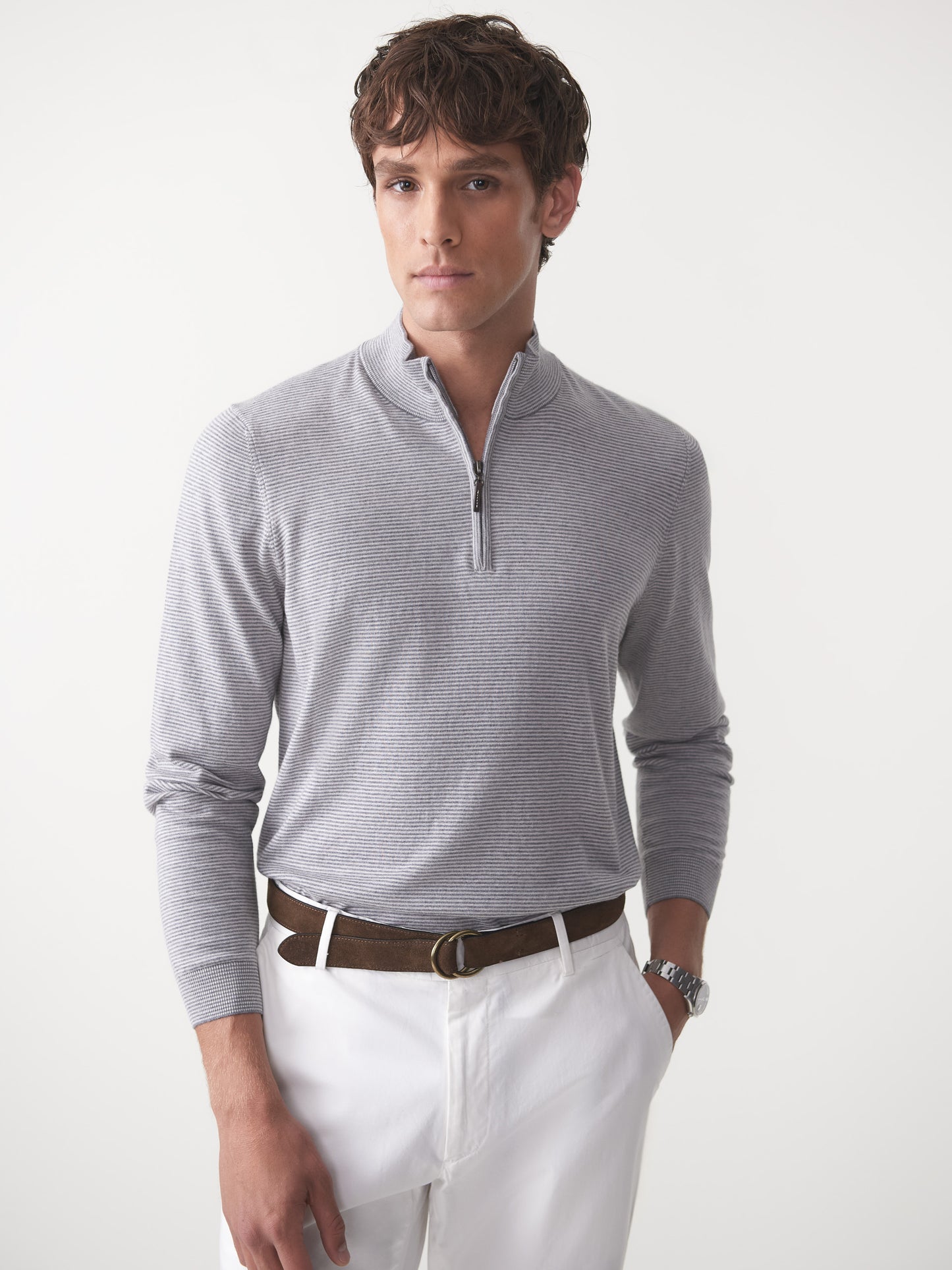 Model wearing J.McLaughlin Brookhaven sweater in gray/light gray made with cotton, viscose, nylon, and cashmere.