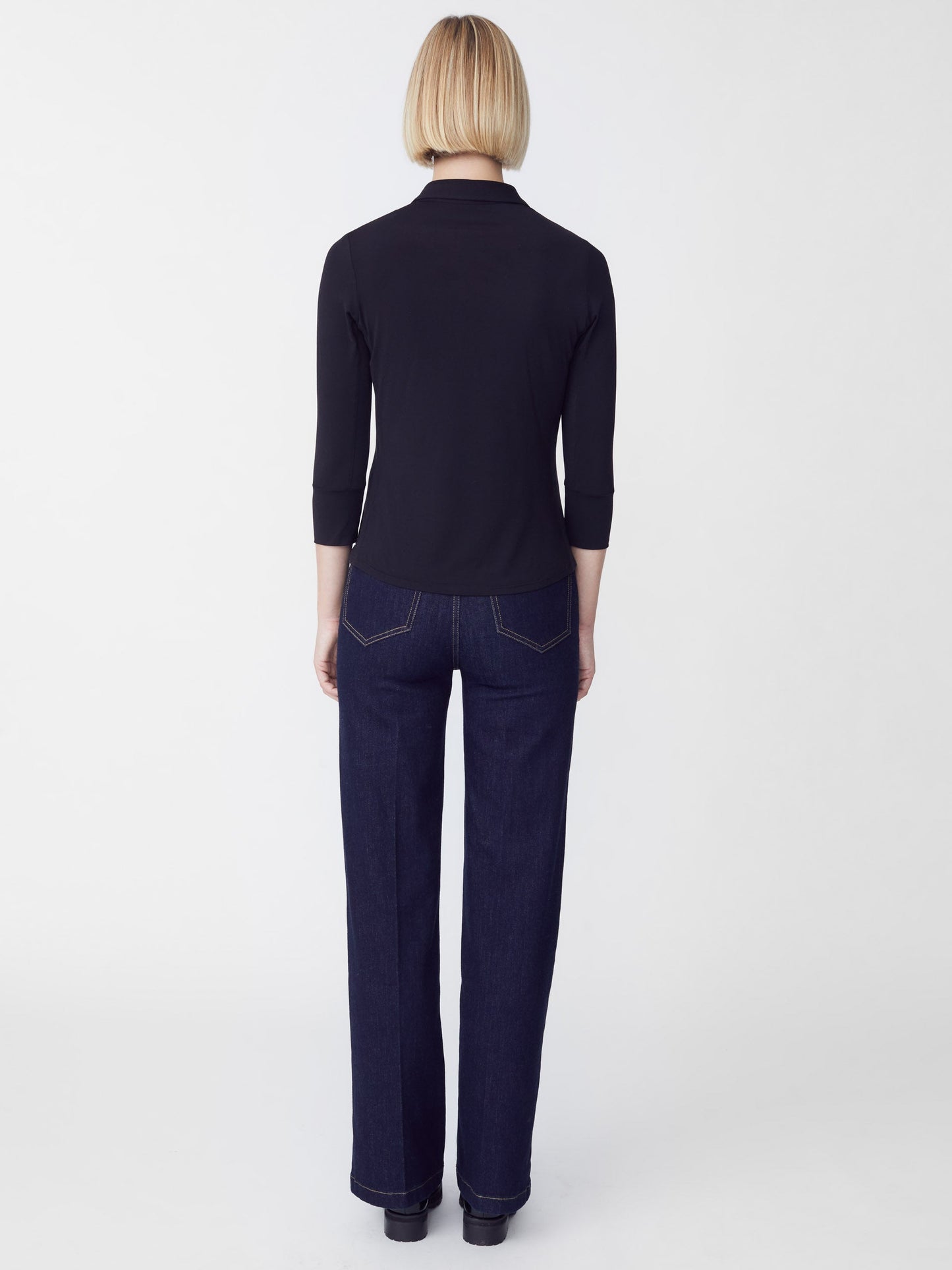 Model wearing J.McLaughlin Brynn shirt in black made with Lyford jersey fabric.