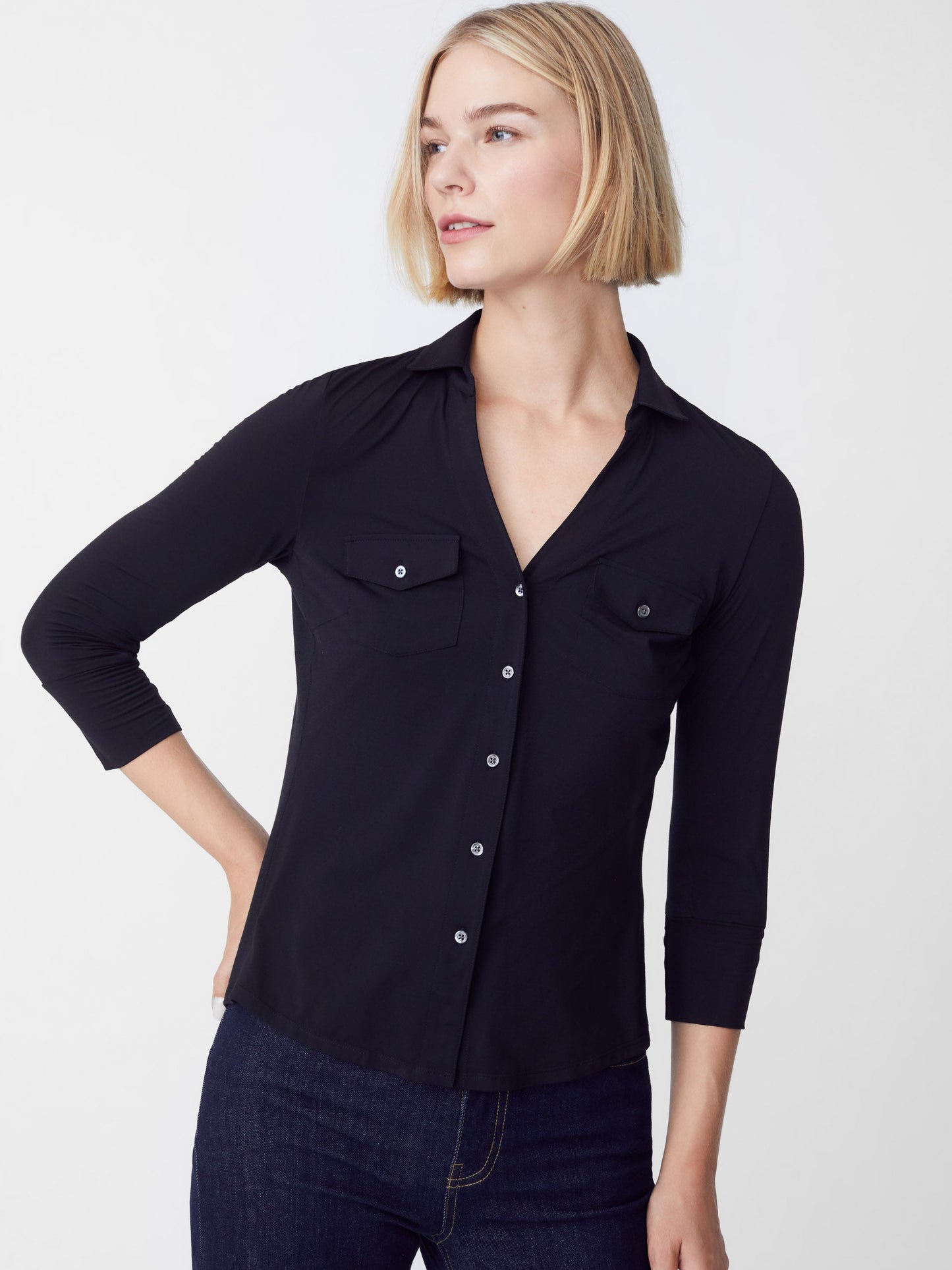 Model wearing J.McLaughlin Brynn shirt in black made with Lyford jersey fabric.