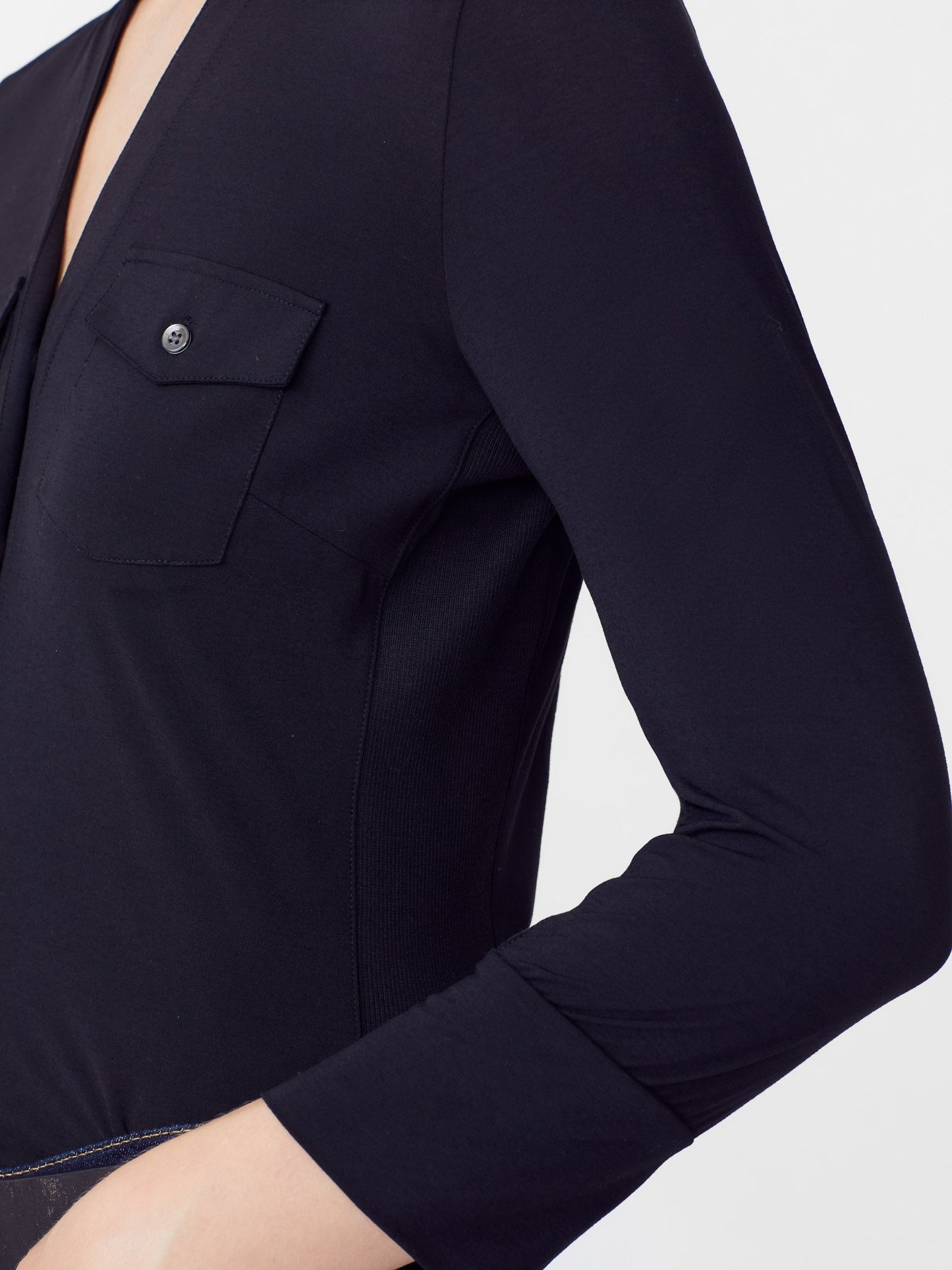 Model wearing J.McLaughlin Brynn shirt in black made with Lyford jersey fabric.