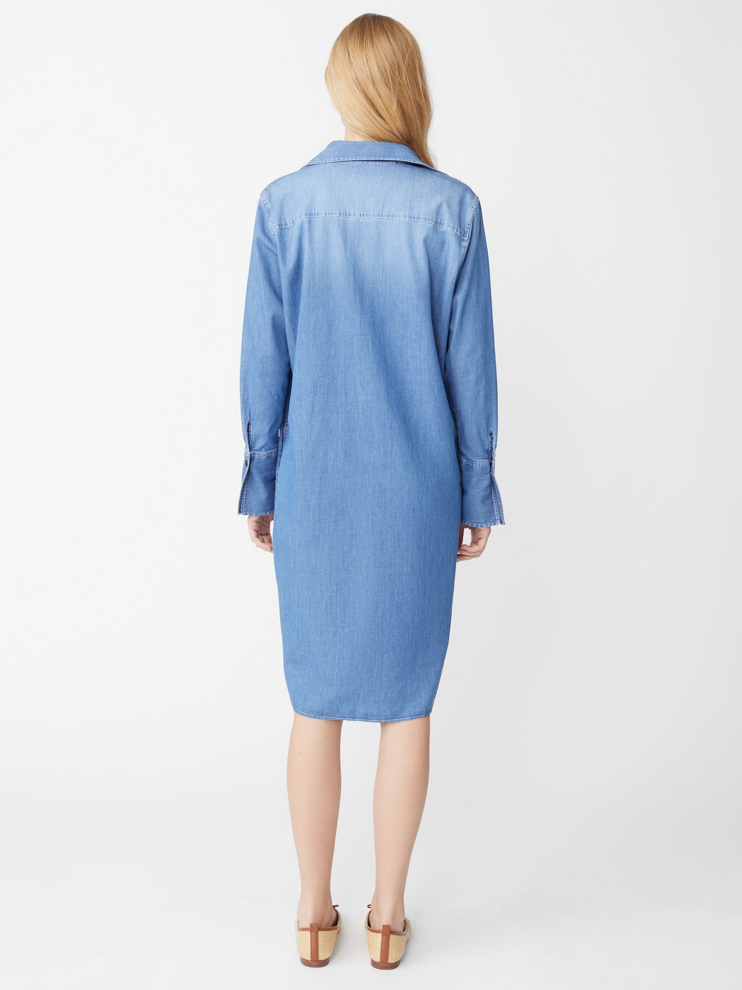 Model wears J.McLaughlin Cagney dress in denim made with cotton/spandex.
