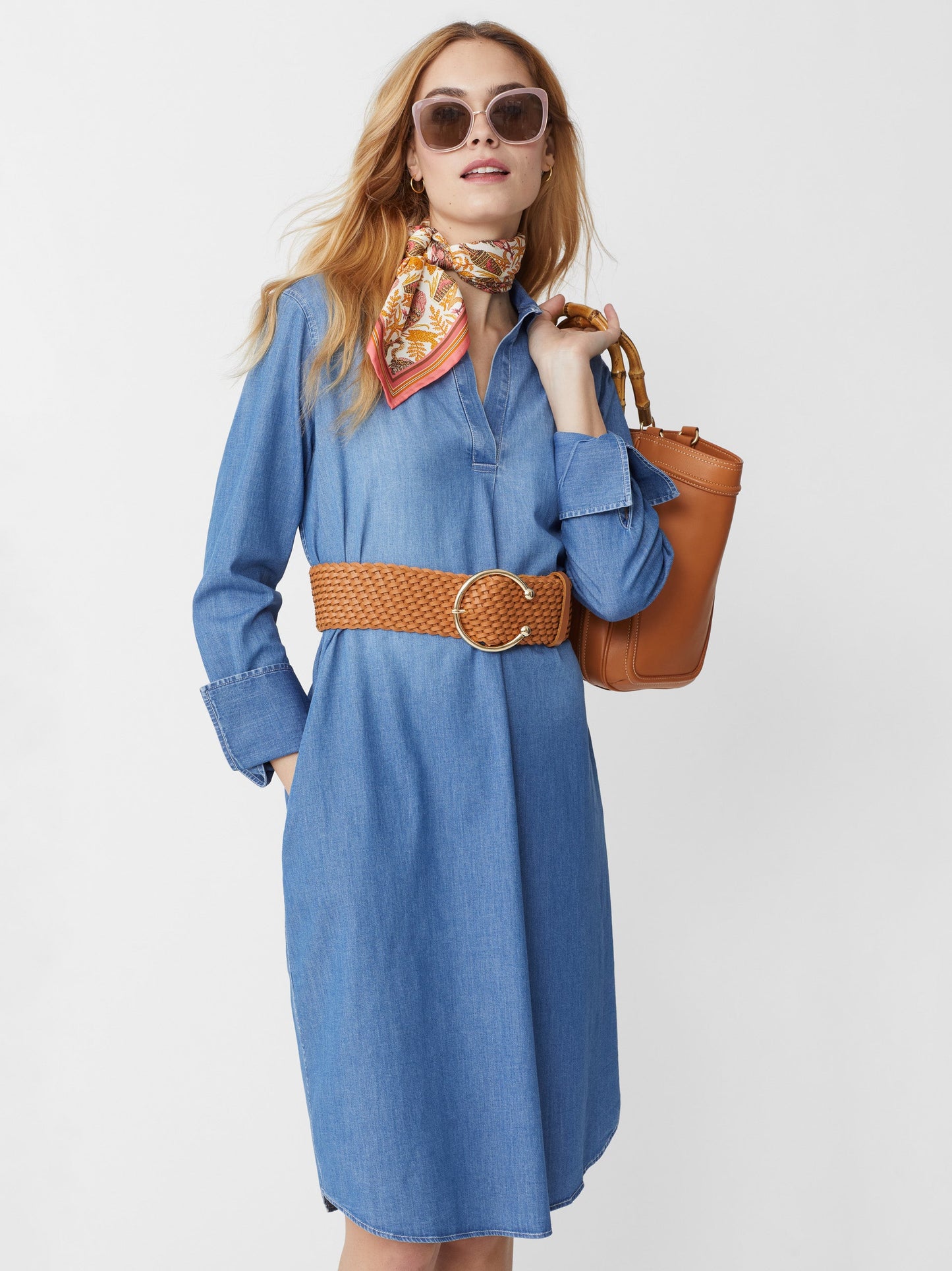 Model wears J.McLaughlin Cagney dress in denim made with cotton/spandex.
