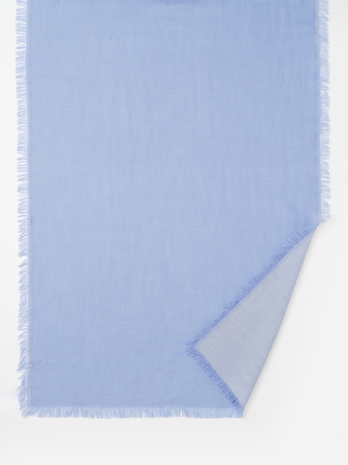 Light blue Carey Cashmere Scarf by J.McLaughlin featuring fine craftsmanship and delicate fringe edges, embodying effortlessly stylish, enduring designs and a legacy of timeless fashion.