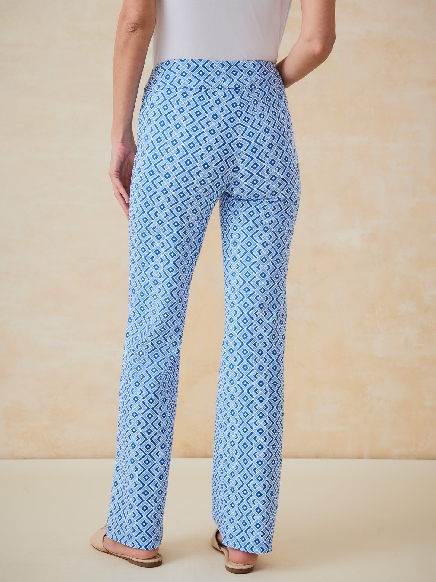 Back view of a model wearing J.McLaughlin Carmel Pants in Quilted Diamond pattern, showcasing effortlessly stylish, enduring designs with a legacy of timeless fashion.