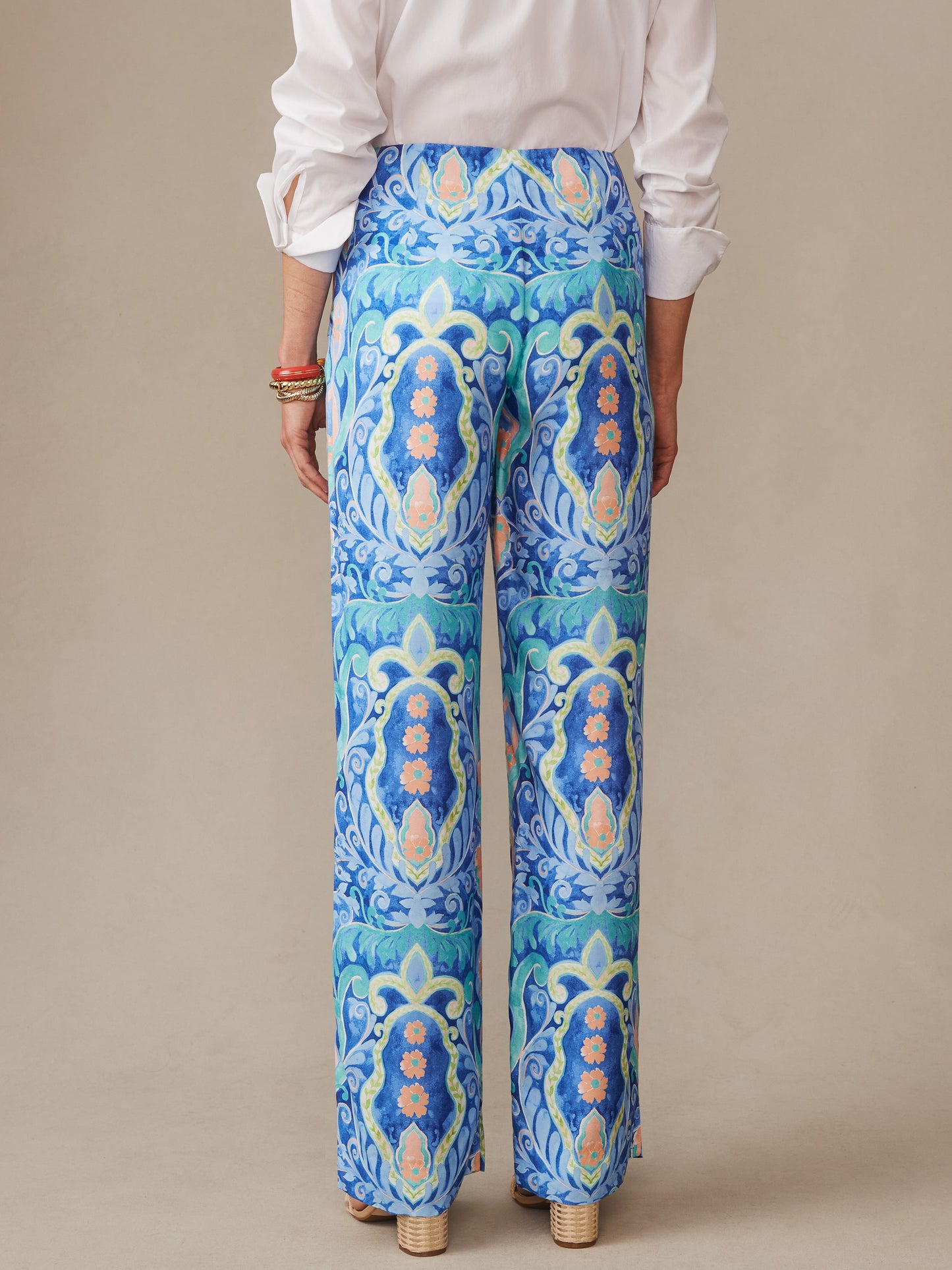 A model wearing J. McLaughlin Carter Silk Blend Pants in Mini Deco Bloom, showcasing effortlessly stylish pants with enduring designs and innovative fabrics, embodying a legacy of timeless fashion. A destination for defining style. Life, Well-Lived.