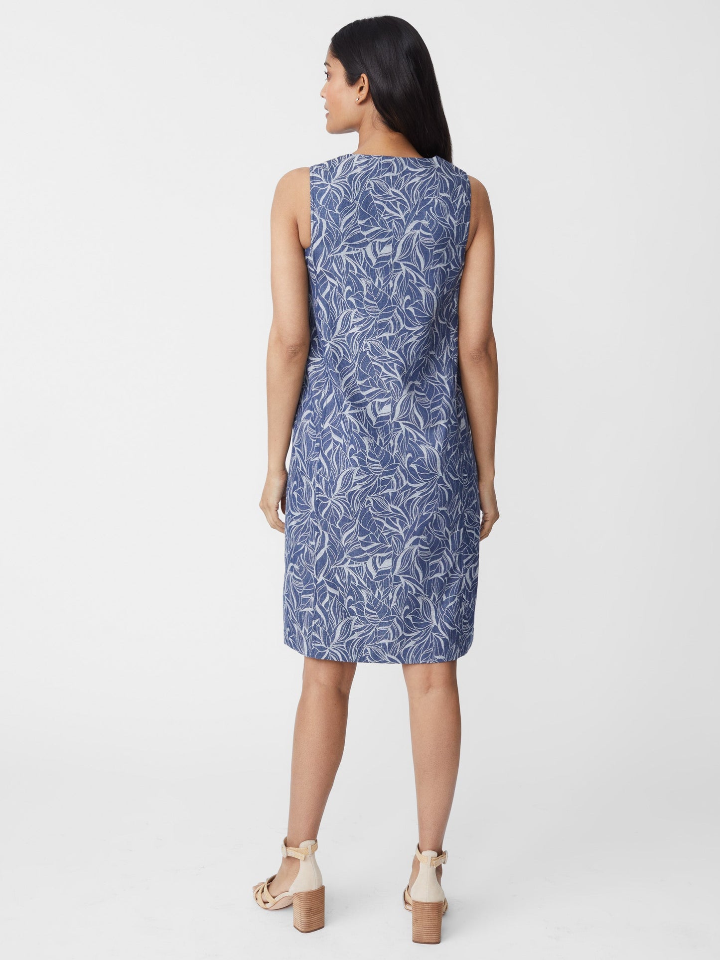 Model wears J.McLaughlin Charlee Denim Dress in denim made with cotton.