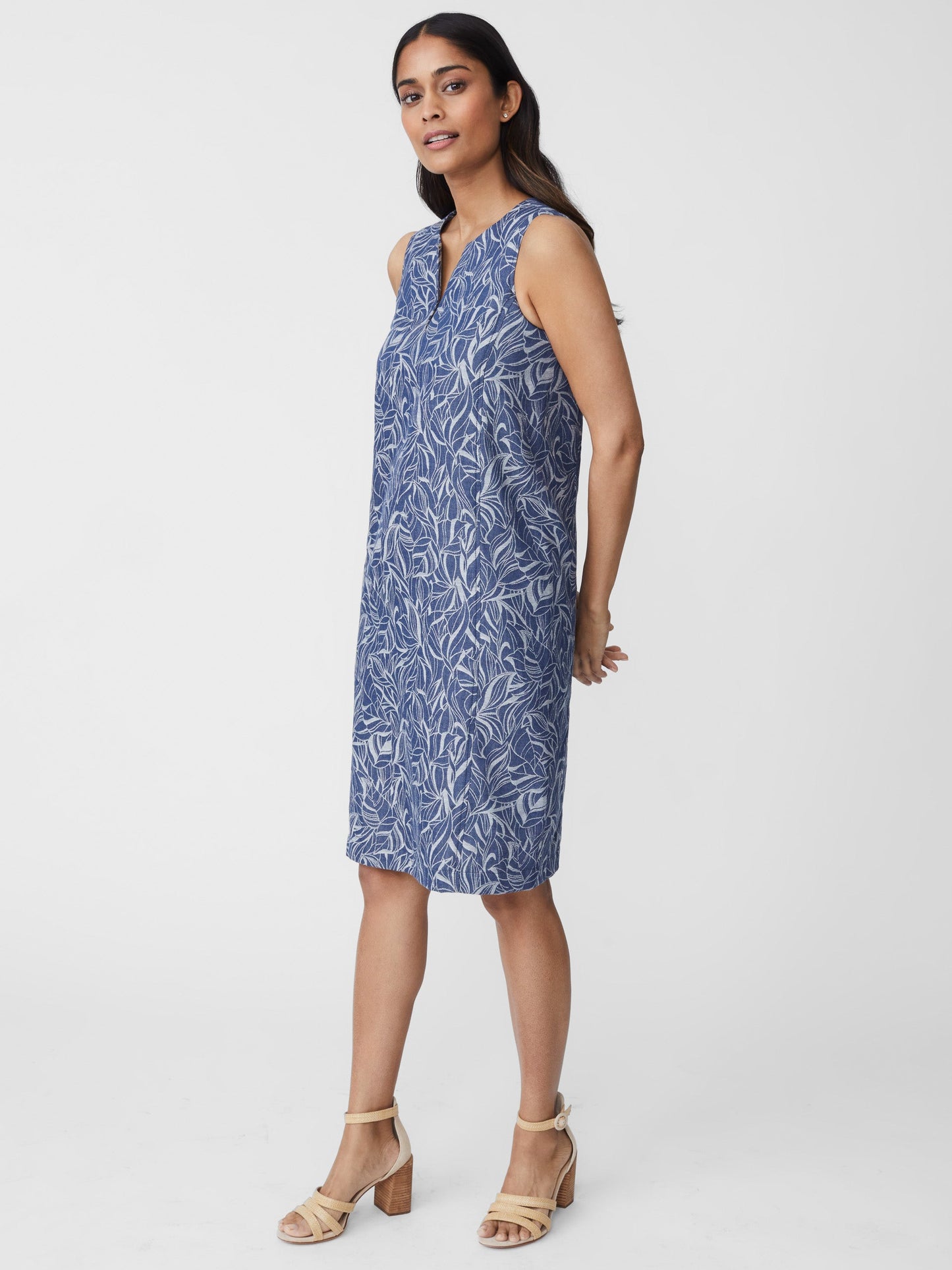 Model wears J.McLaughlin Charlee Denim Dress in denim made with cotton.