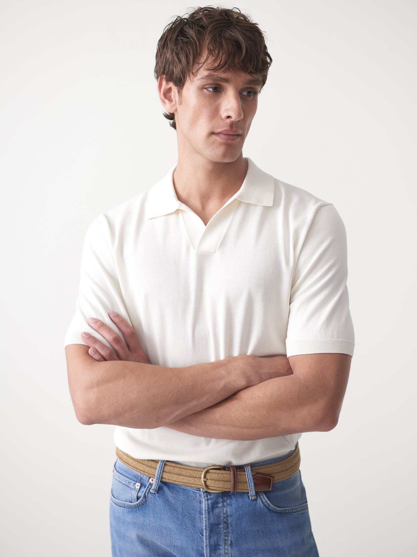 Model wearing J.McLaughlin Cillian sweater polo in egret white made with cotton.