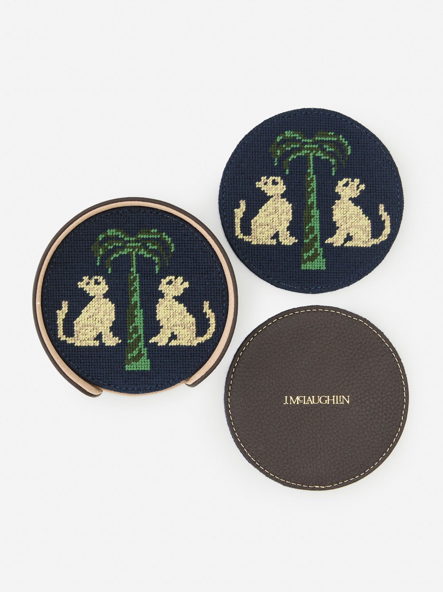 J.McLaughlin Coaster set in dark brown/khaki made with cotton needlepoint and leather.