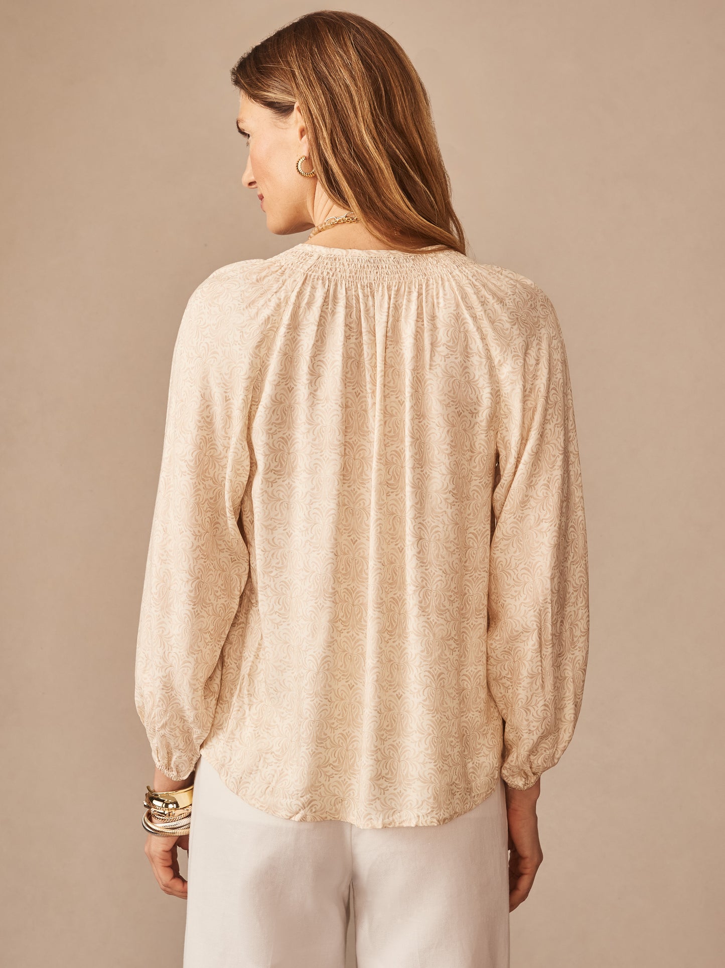Woman wearing a lightweight Constance Silk Blend Blouse in Mini Drawing Room by J.McLaughlin, featuring a delicate off-white pattern and relaxed long sleeves, embodying effortlessly stylish, enduring designs with innovative fabrics. A destination for defining style. Life, Well-Lived.