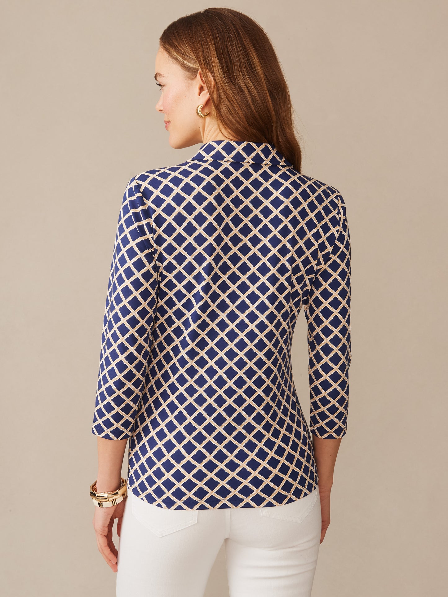 Woman wearing a Court 3/4 Sleeve Polo in Micro Bamboo with a navy and sand geometric pattern, showcasing effortless style and enduring design by J.McLaughlin, a destination for defining style. Life, Well-Lived.
