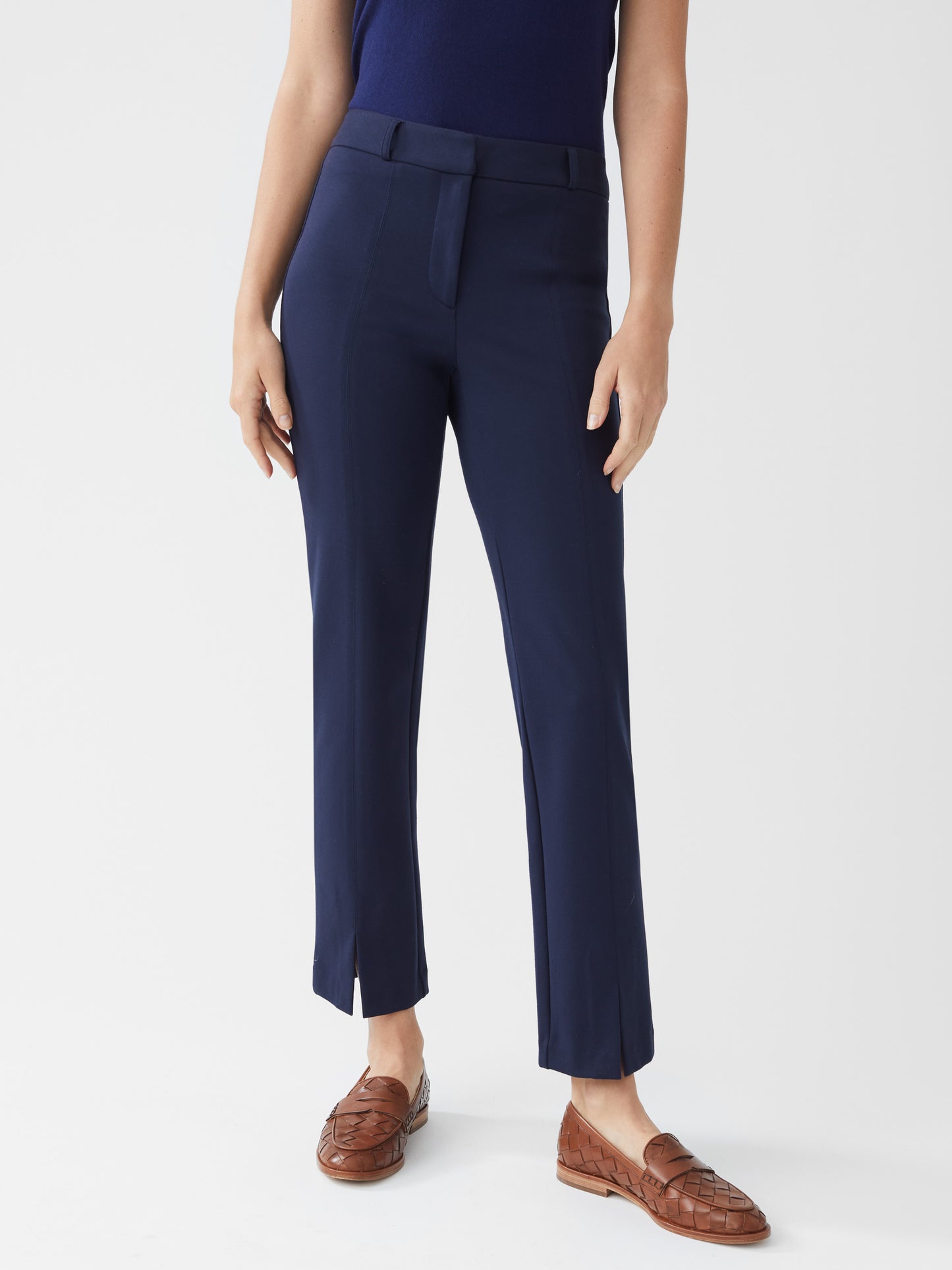 Model wearing J.McLaughlin Deanne pants in winter navy made with bainbridge fabric.