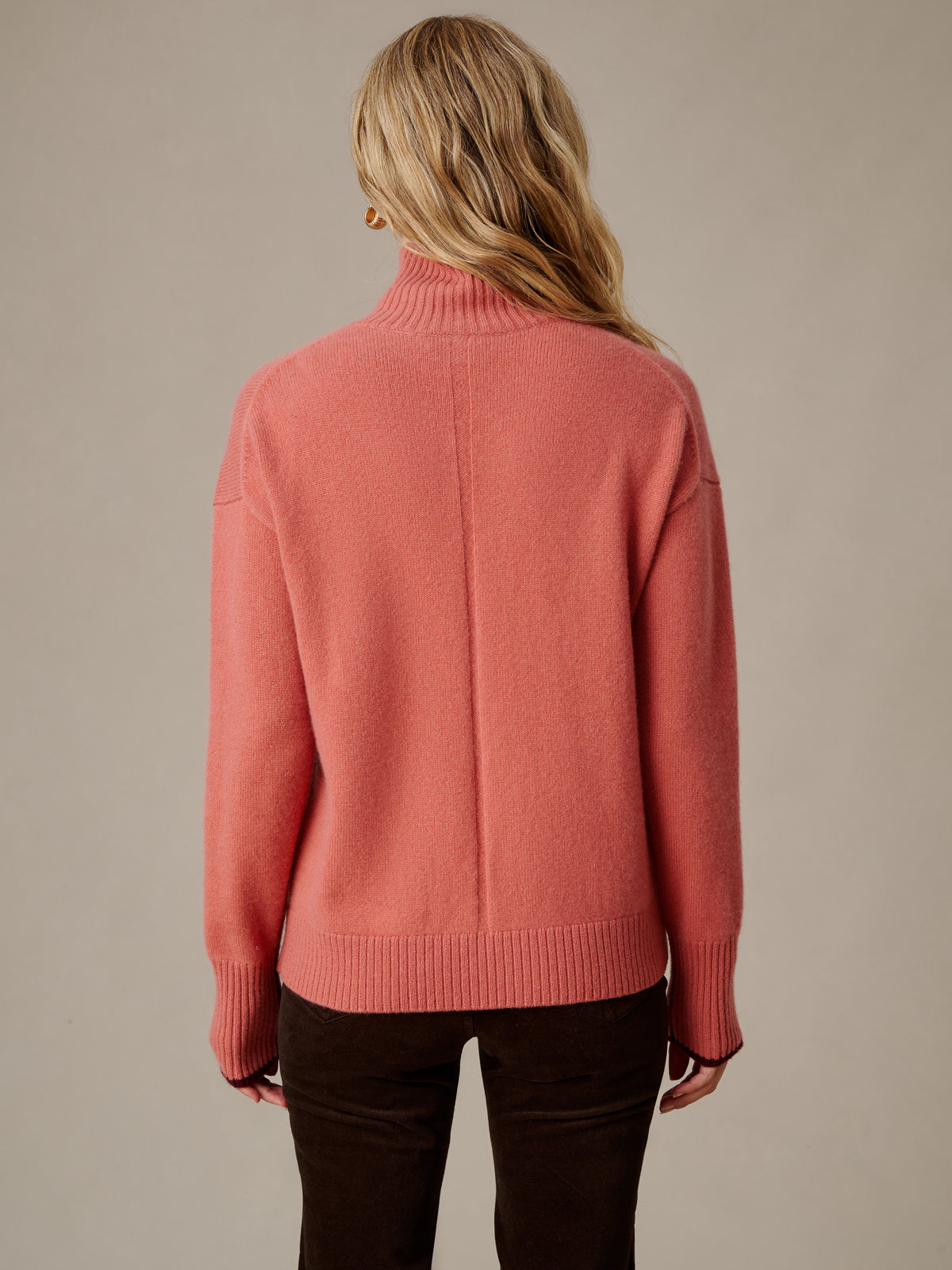 Dina Cashmere Turtleneck by J.McLaughlin in soft coral with ribbed collar and cuffs shown from the back for a timeless and effortlessly stylish look