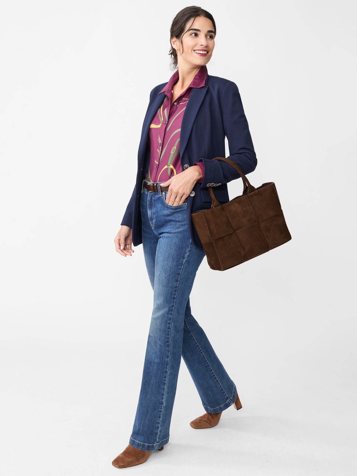 Model wearing J.McLaughlin Domino jeans in dark indigo made with woven denim.