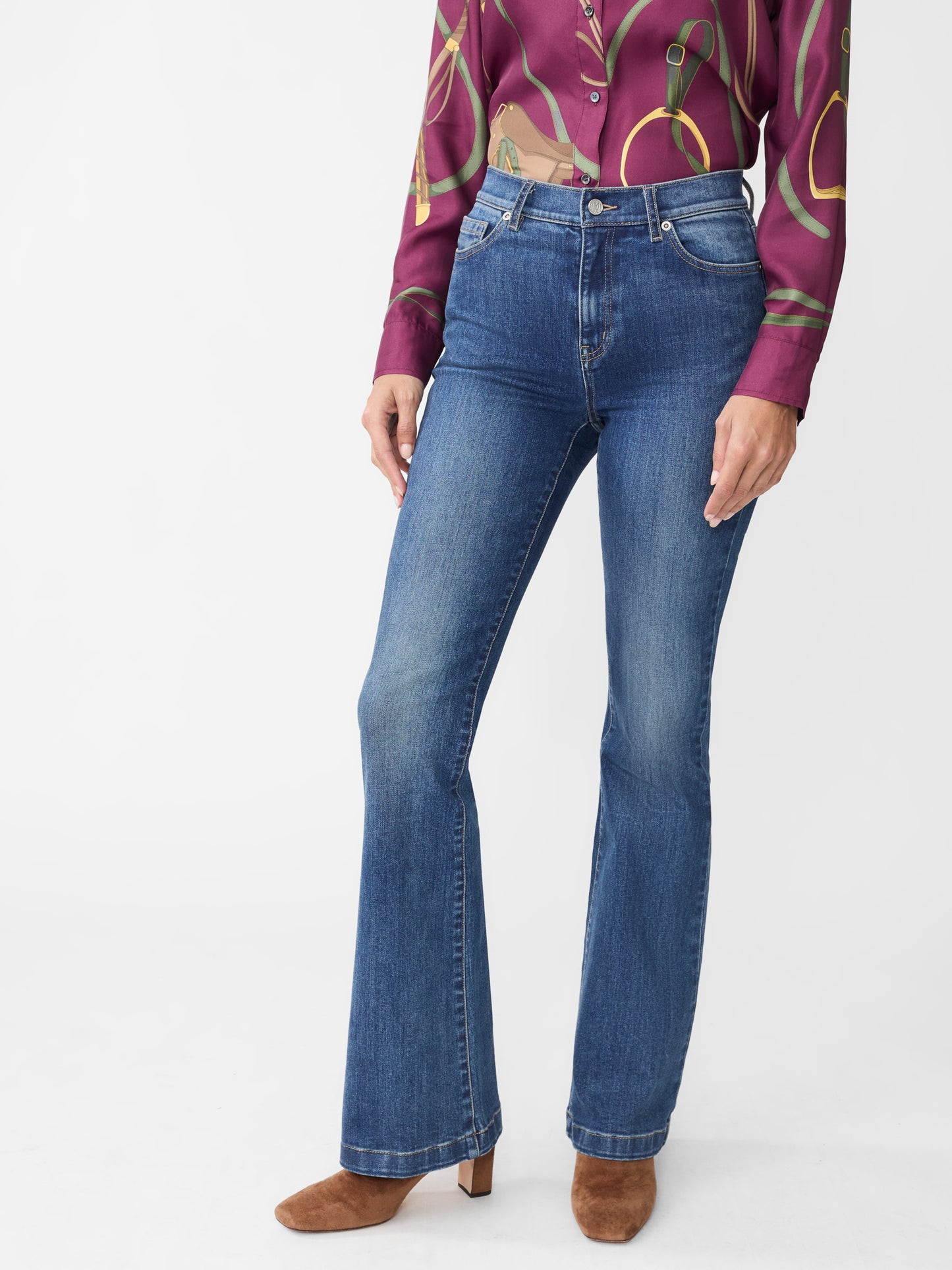 Model wearing J.McLaughlin Domino jeans in dark indigo made with woven denim.