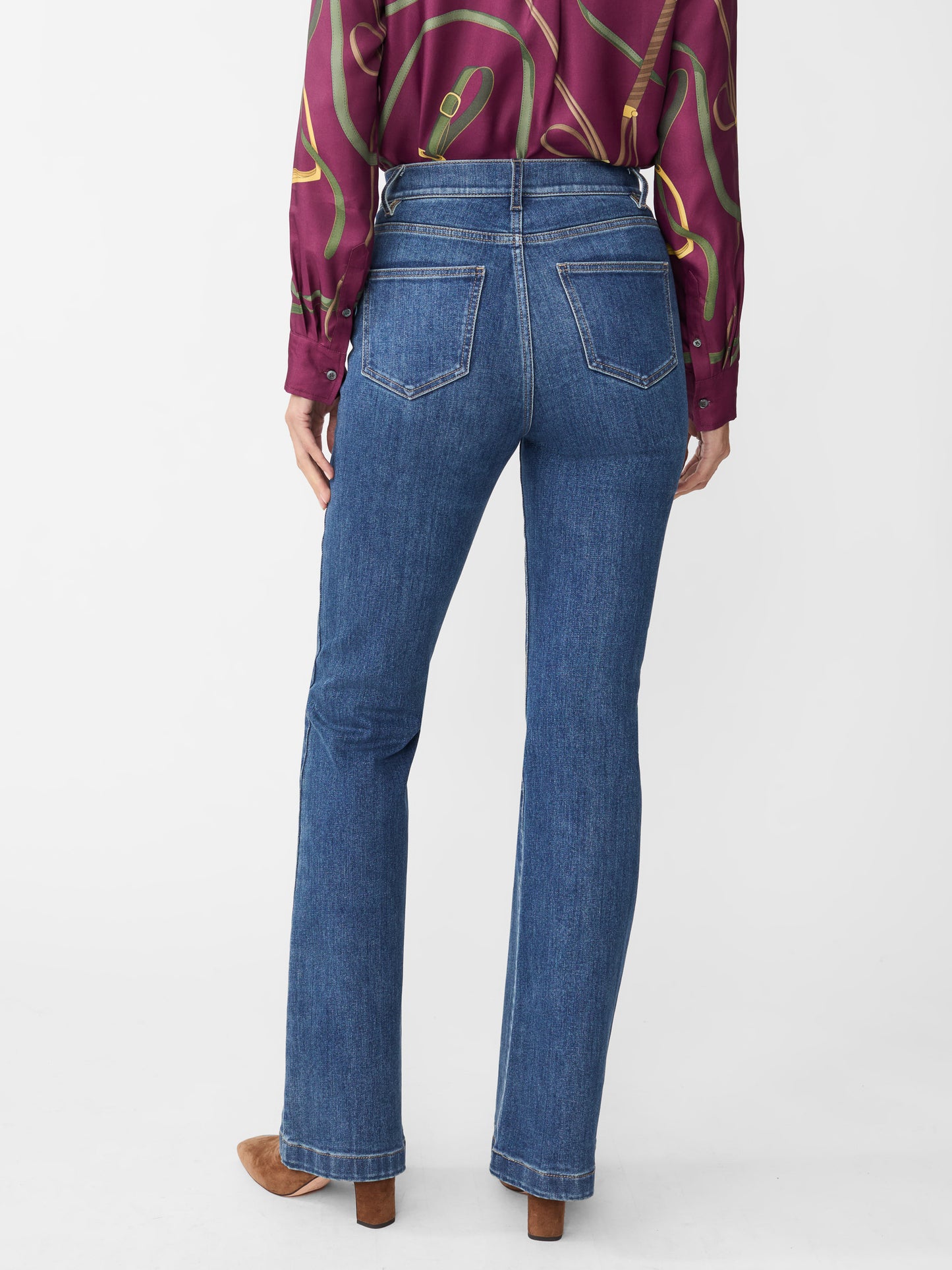 Model wearing J.McLaughlin Domino jeans in dark indigo made with woven denim.