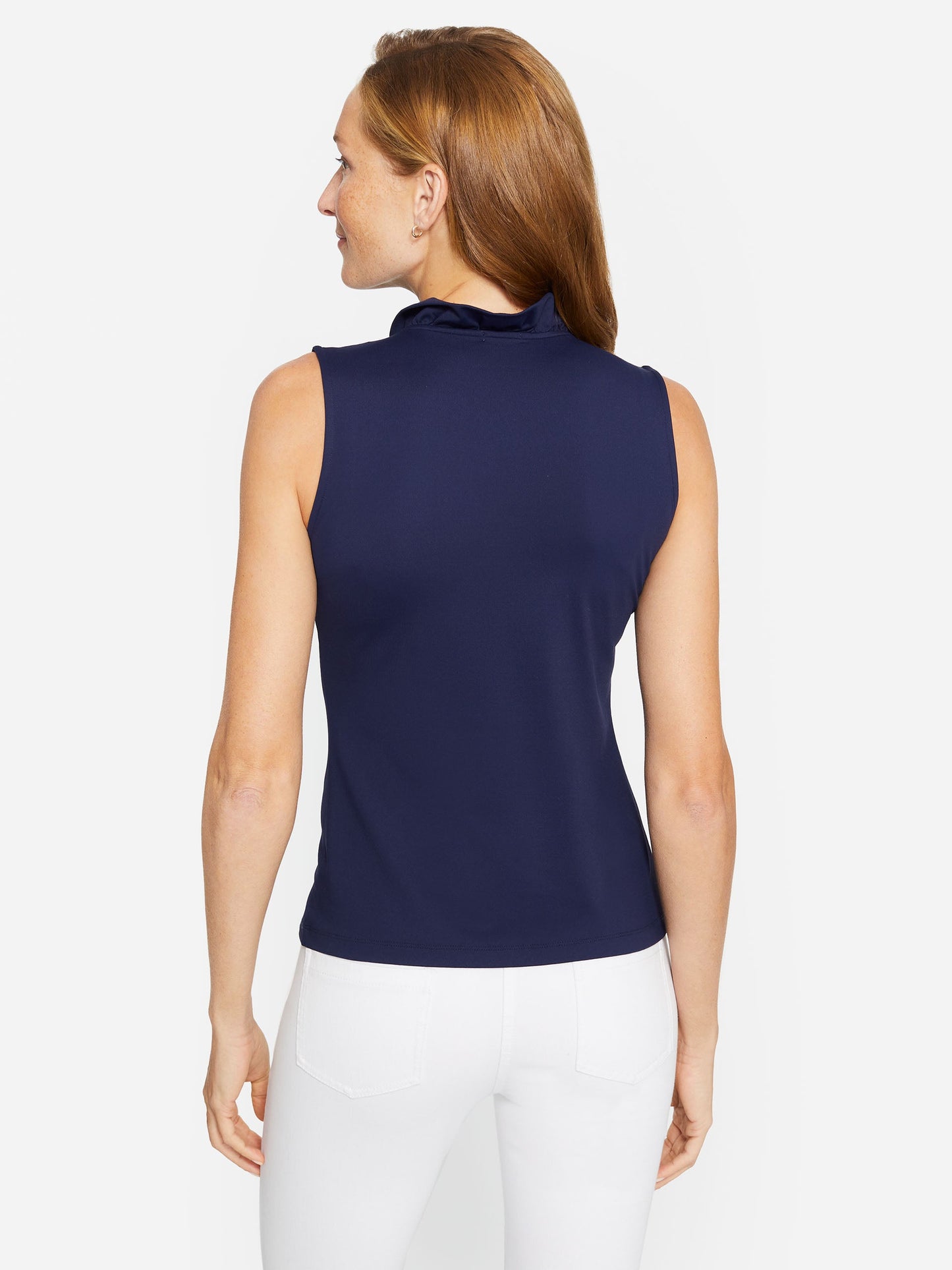 Model wearing J.McLaughlin Durham sleeveless ruffle top in winter navy made with Catalina cloth.