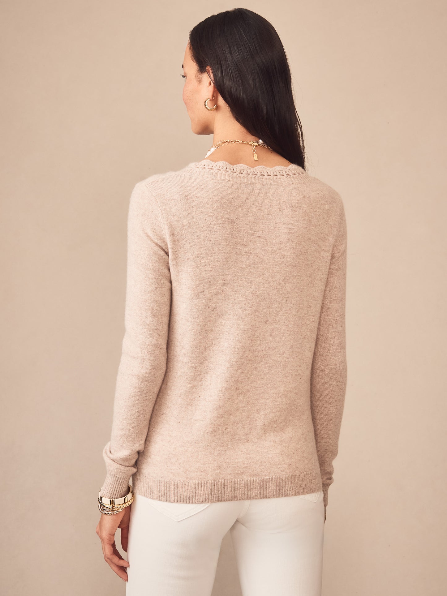 Woman wearing an oatmeal-colored Evelyn Cashmere Sweater by J.McLaughlin, showcasing effortlessly stylish, enduring designs with a legacy of timeless fashion, a destination for defining style. Life, Well-Lived.