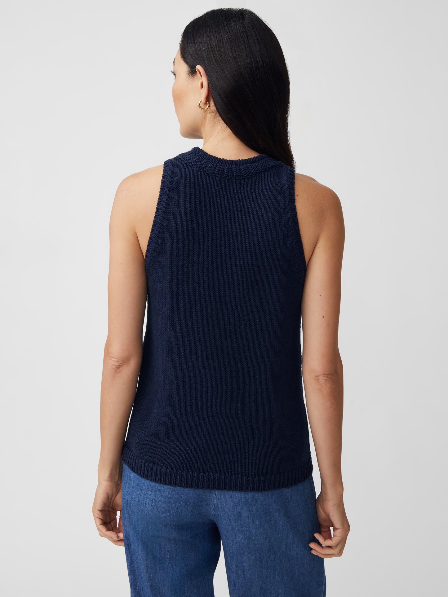 J.McLaughlin model wears Felicity Sleeveless Sweater in navy made with cotton/linen.