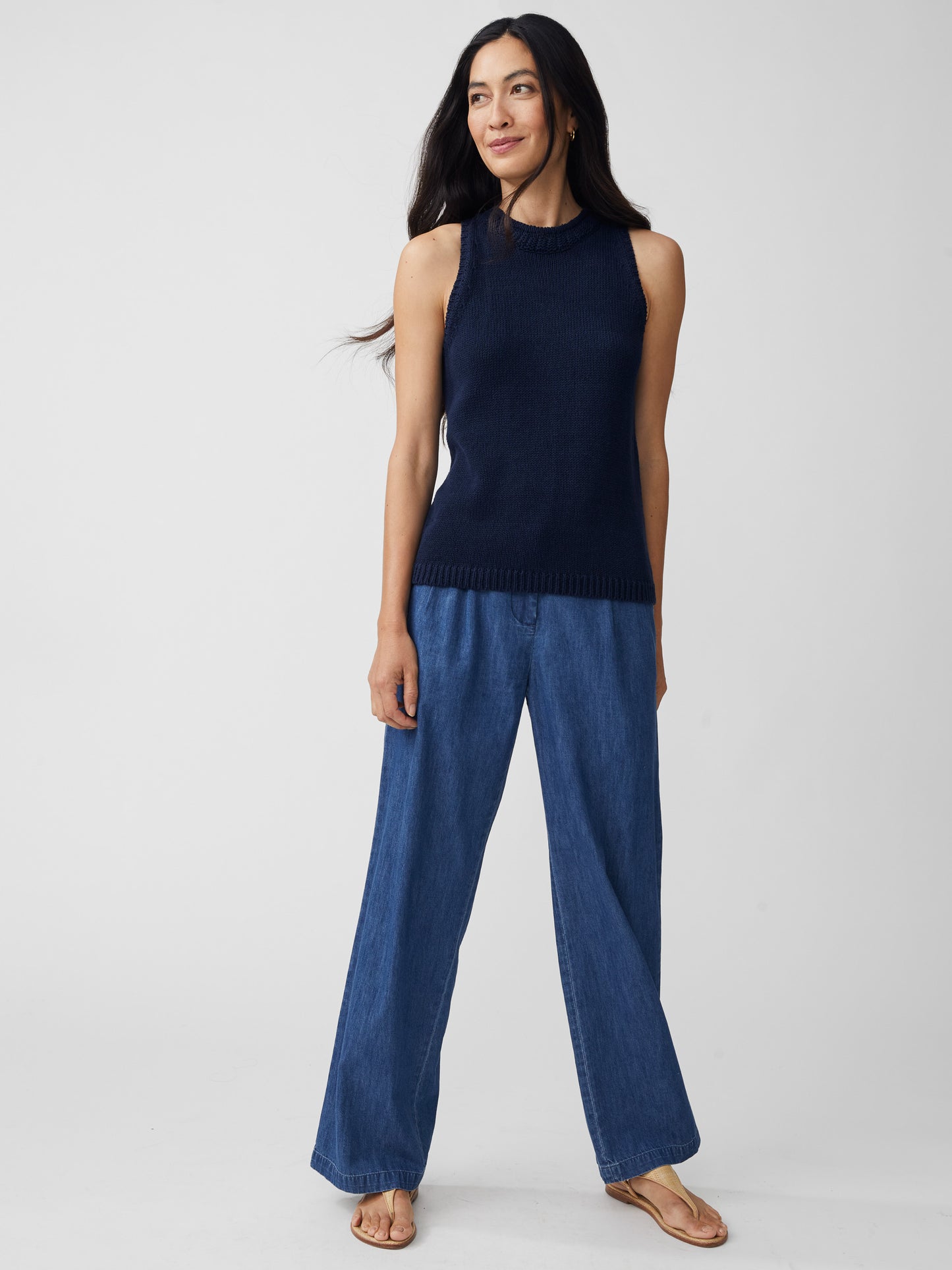 J.McLaughlin model wears Felicity Sleeveless Sweater in navy made with cotton/linen.